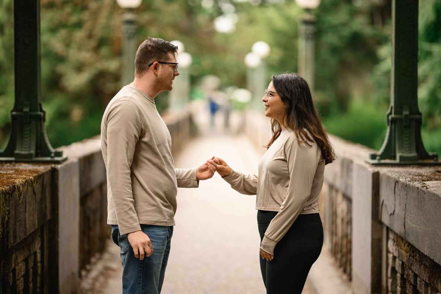 Couple facing each other on the Wilcox Footbridge moments before the proposal, Washington Park Arboretum proposal photographer, Seattle