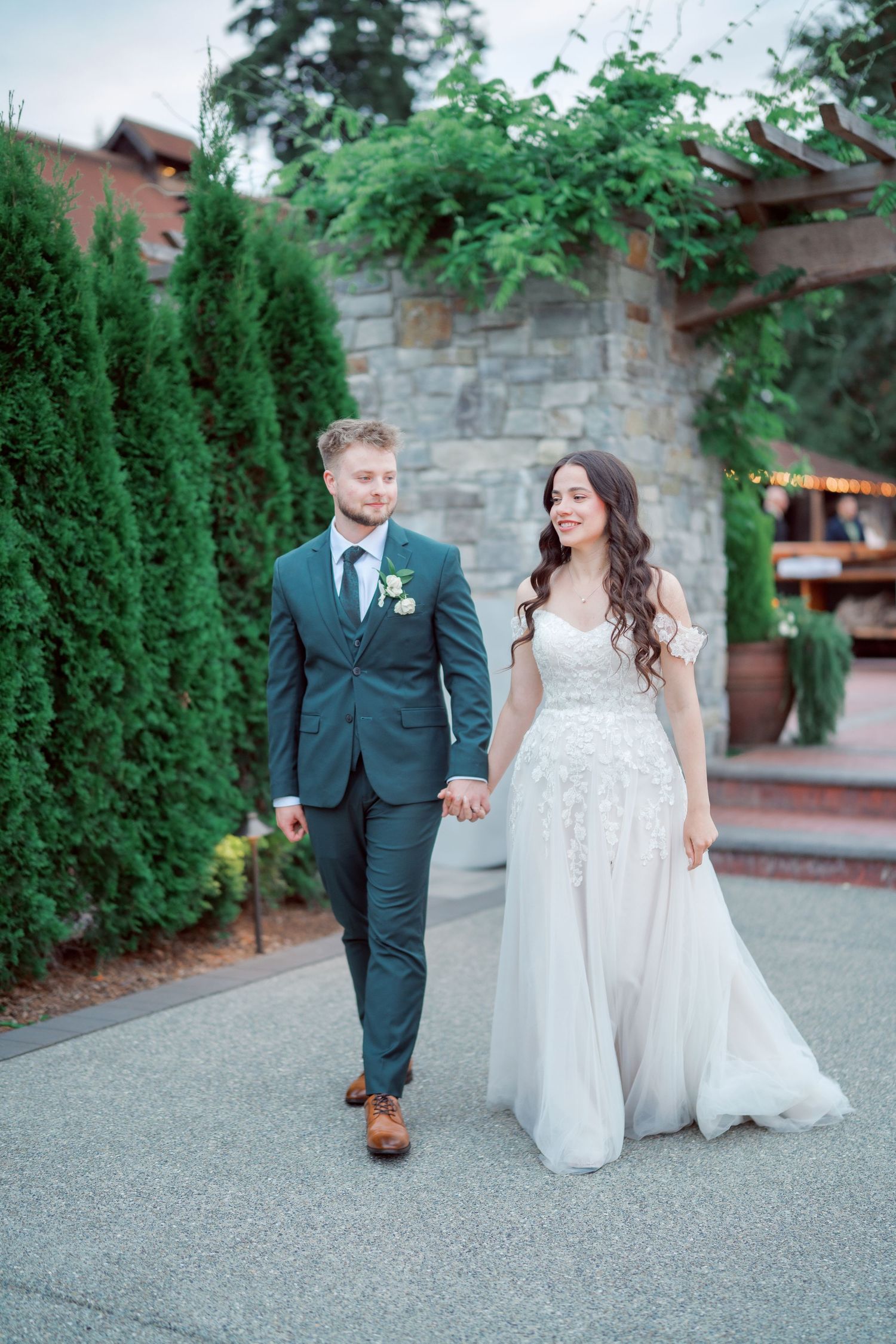 Bride and groom walk the garden path at The Kelley Farm in Bonney Lake