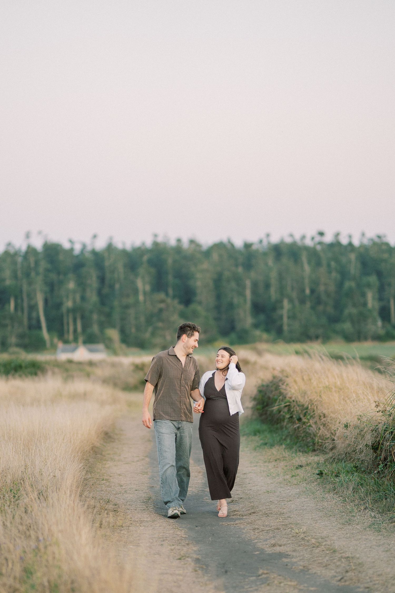 Couple walking the bluff trail toward Frank D. Robinson Beach, Whidbey Island proposal photographer, Freeland