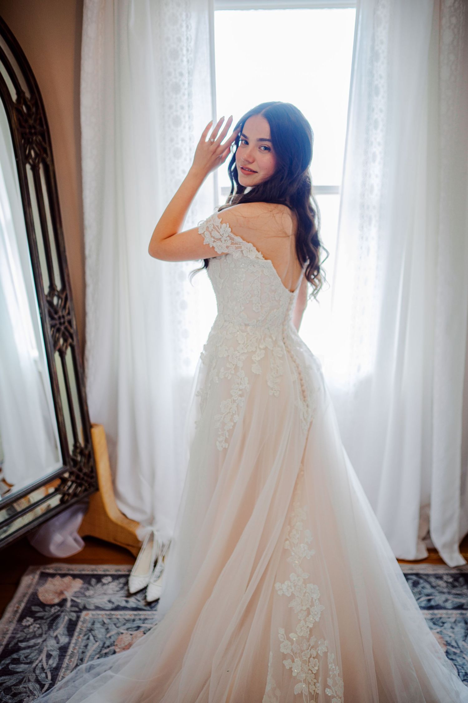 Bride in her gown by the farmhouse window at The Kelley Farm, Bonney Lake