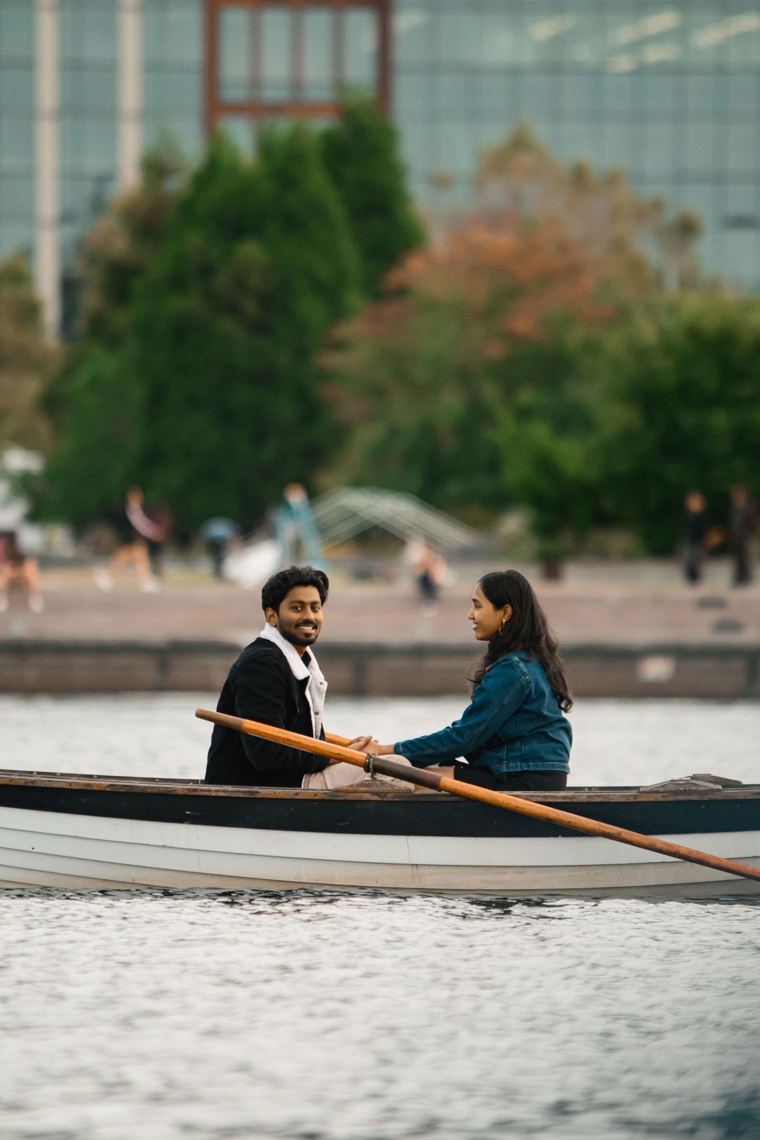 The two of them close together in the row boat before the proposal, Lake Union proposal photographer, Seattle
