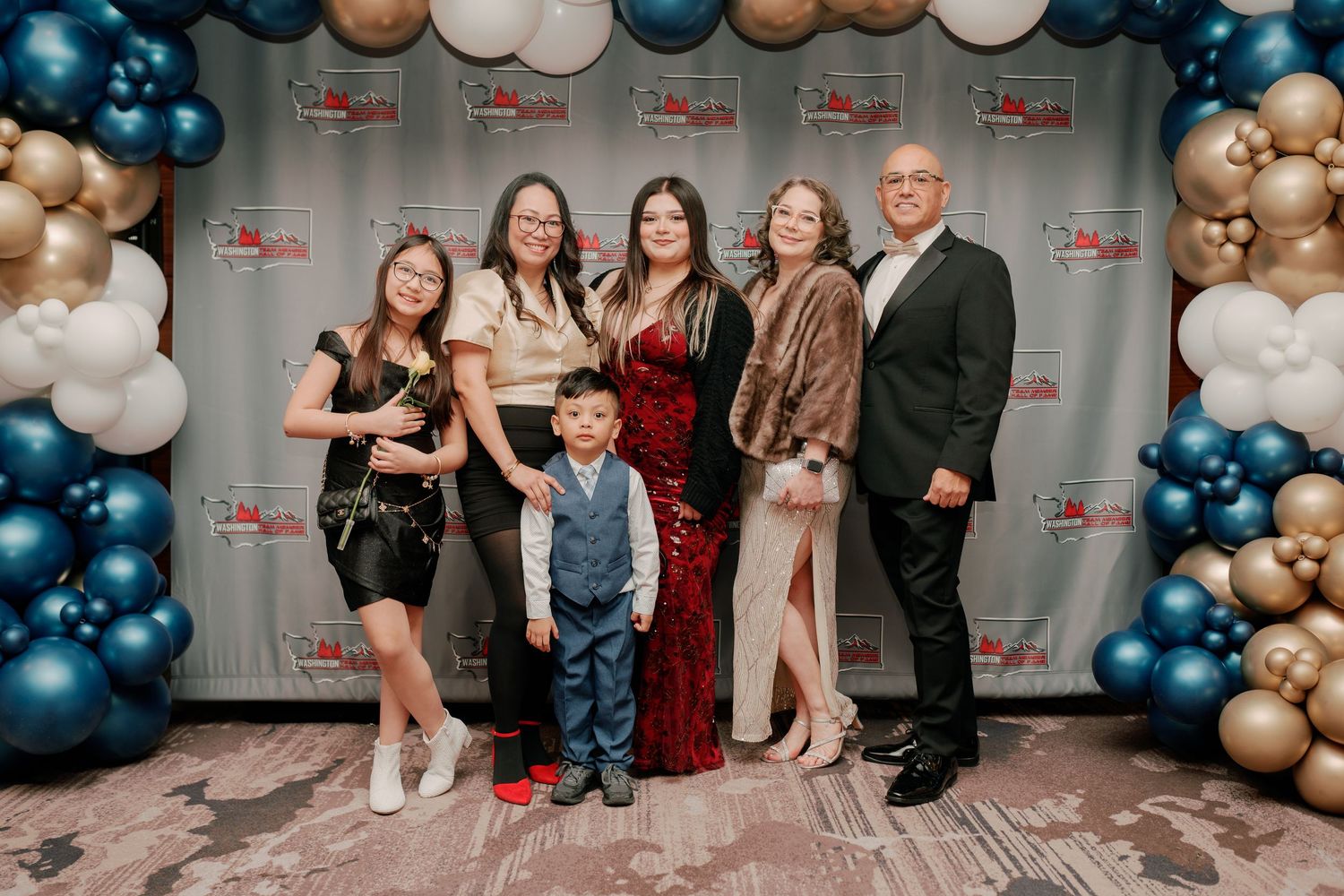 Group portrait at the balloon backdrop, State Farm Hall of Fame gala photography, Renton Washington