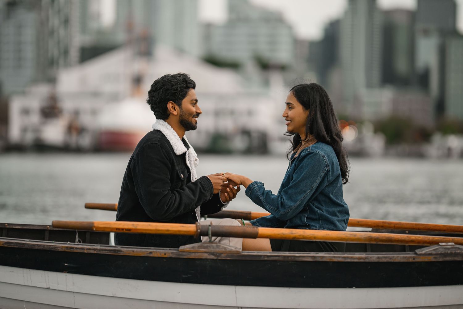 Sitting together in the boat with the Seattle skyline behind, Lake Union proposal photographer, Seattle