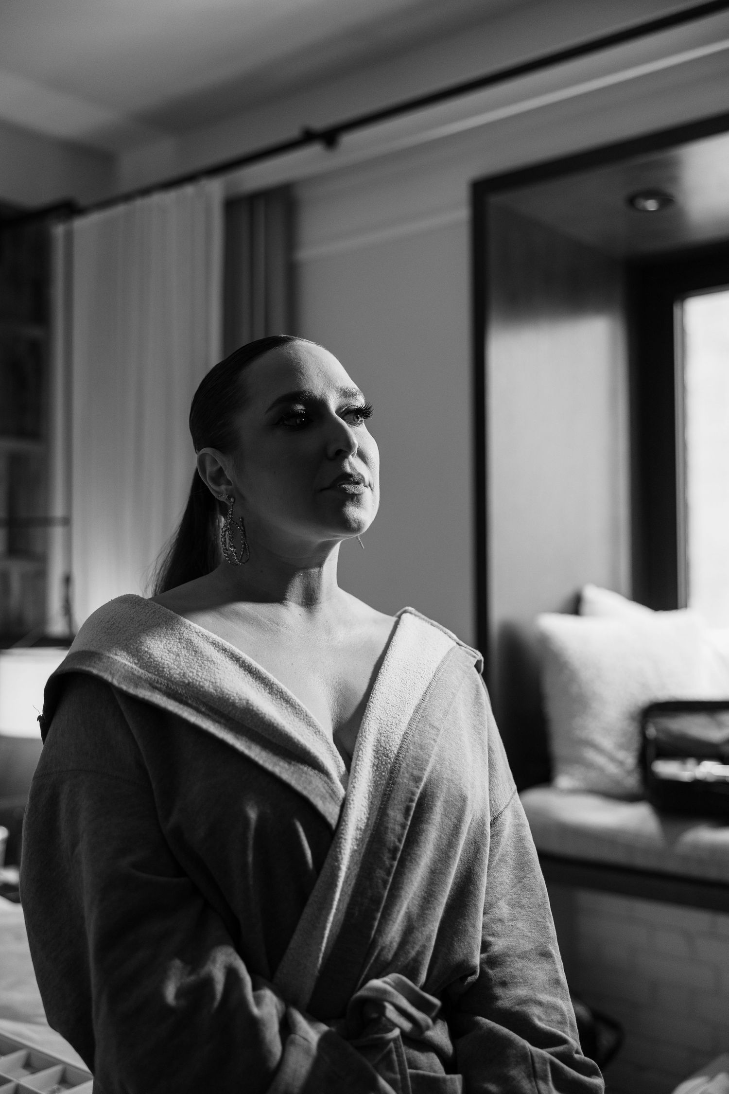 Artistic black and white portrait series showing moody lighting and dramatic shadows in an interior setting.