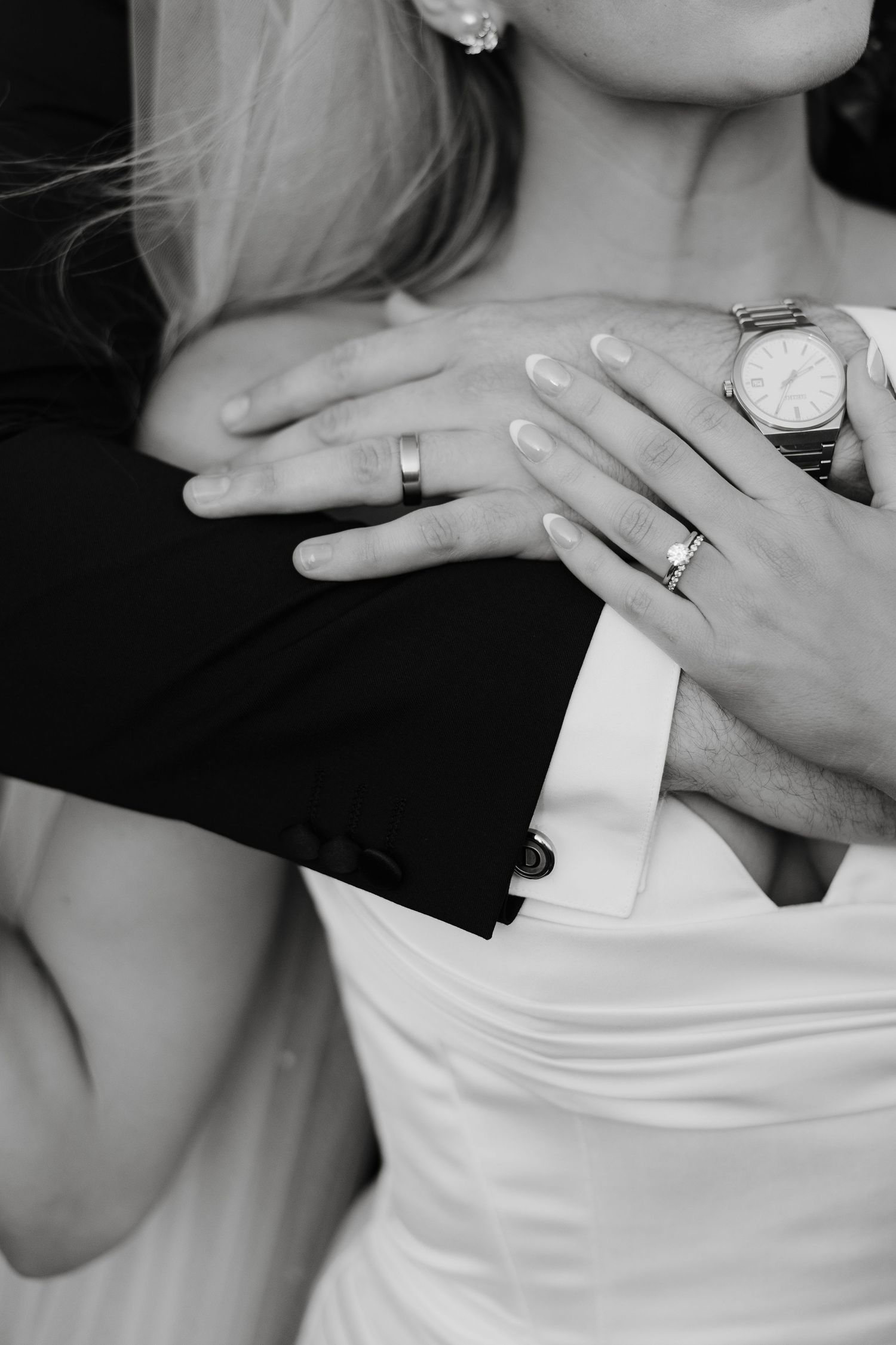 Close-up shots of wedding rings and jewelry details on a bride's hand.