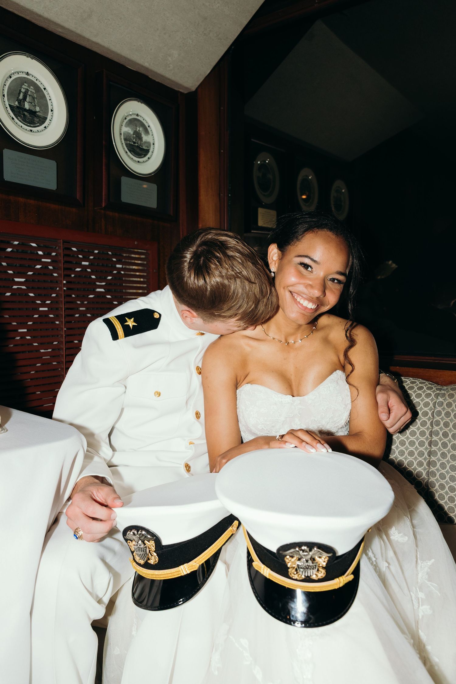 Wedding reception celebration on a boat with nautical decorations and formal attire.