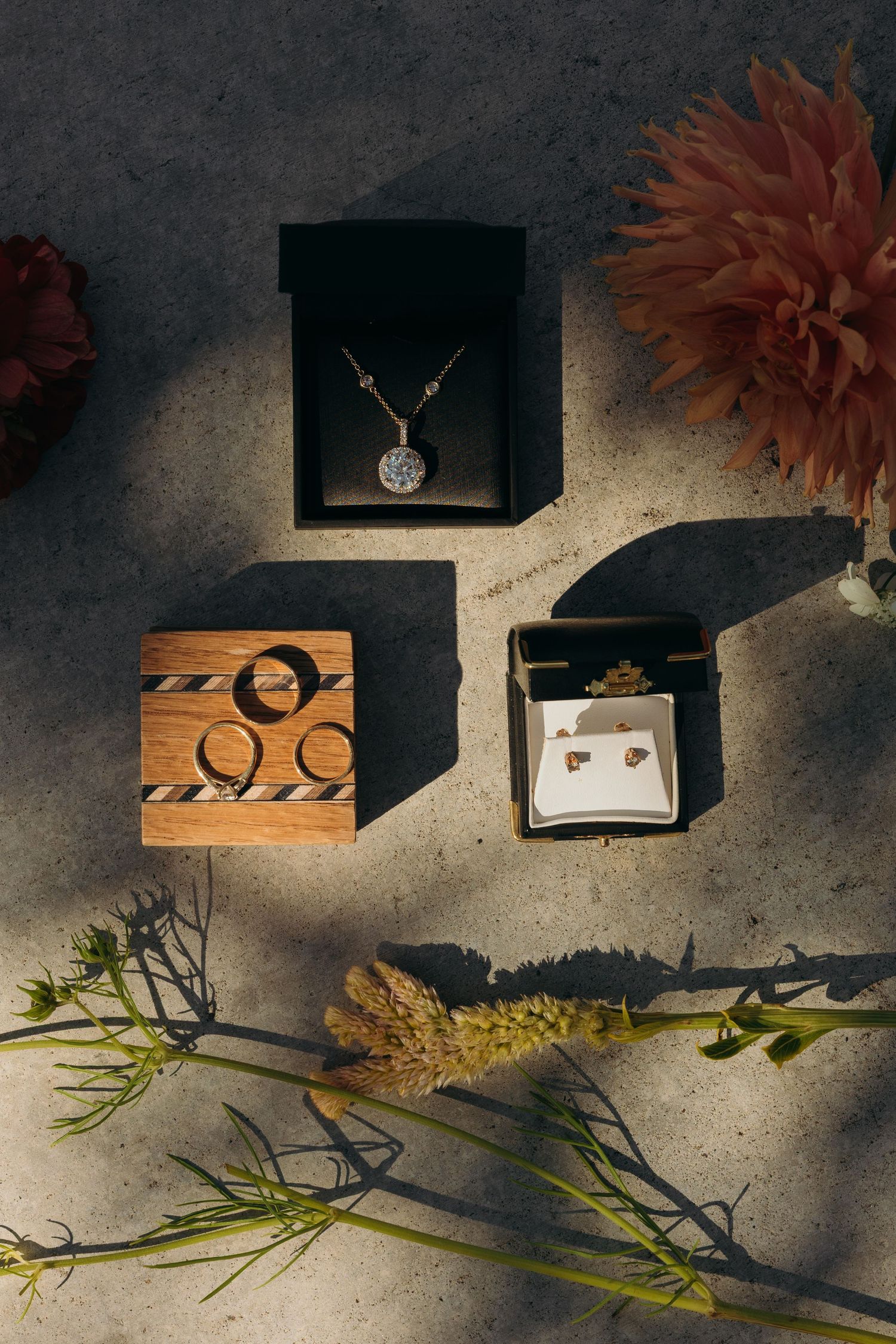 Wedding details and accessories arranged artistically with dramatic lighting.