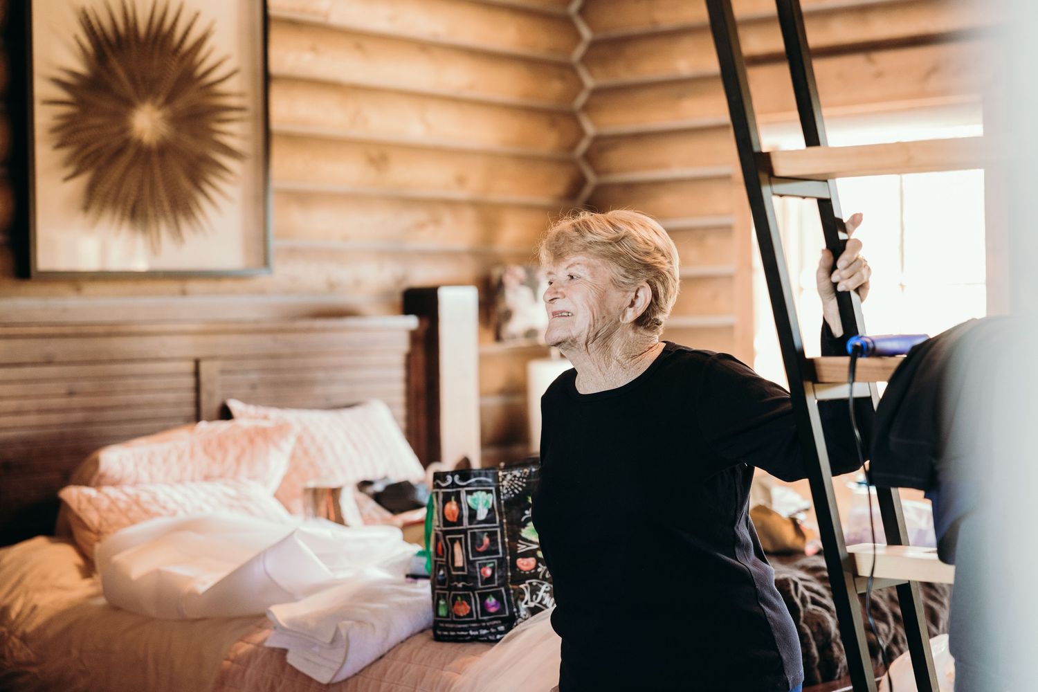 Candid moment during wedding preparations in wooden cabin interior.