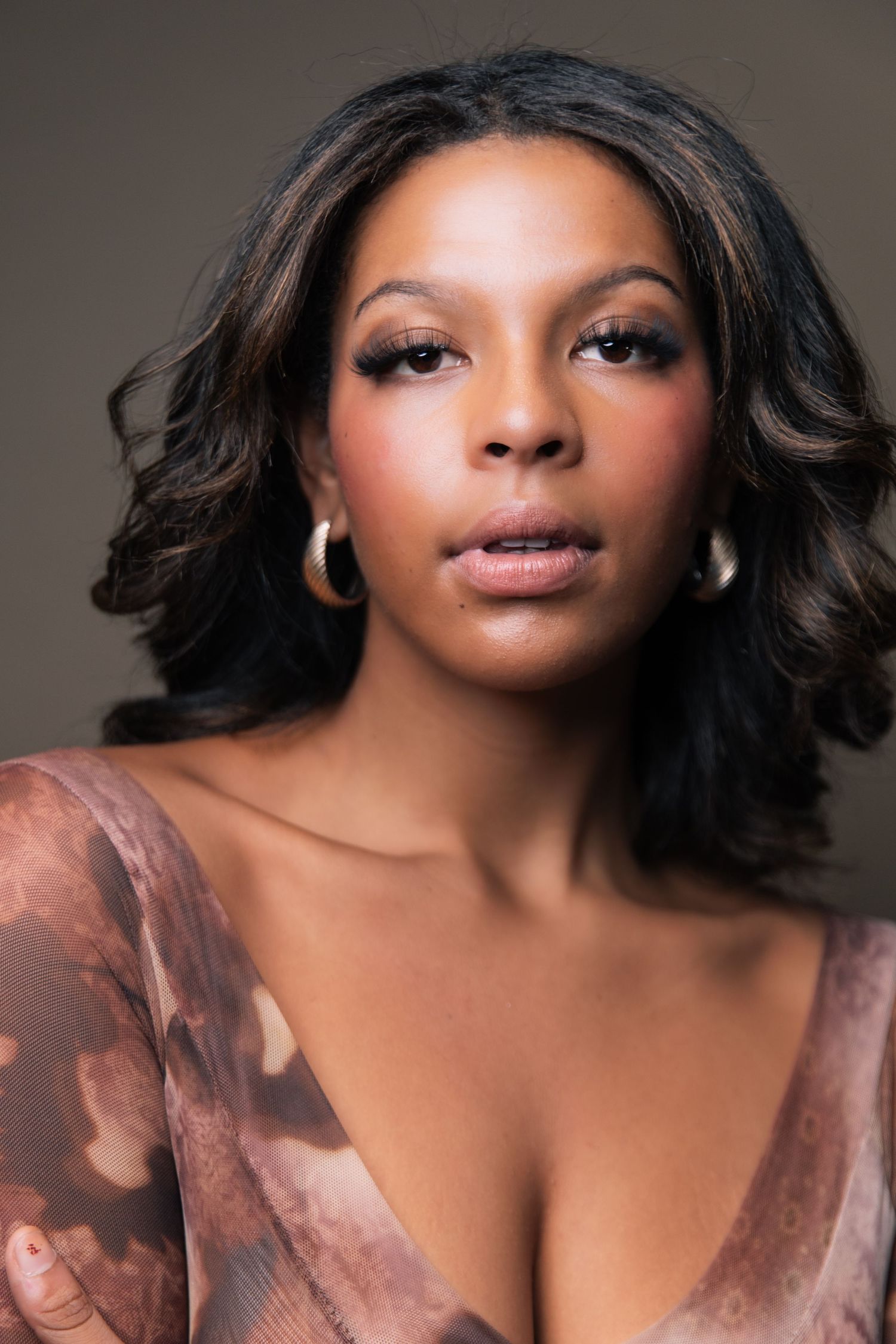 Portrait series showing close-up beauty shots with soft lighting and flowing dark hair against a neutral background.