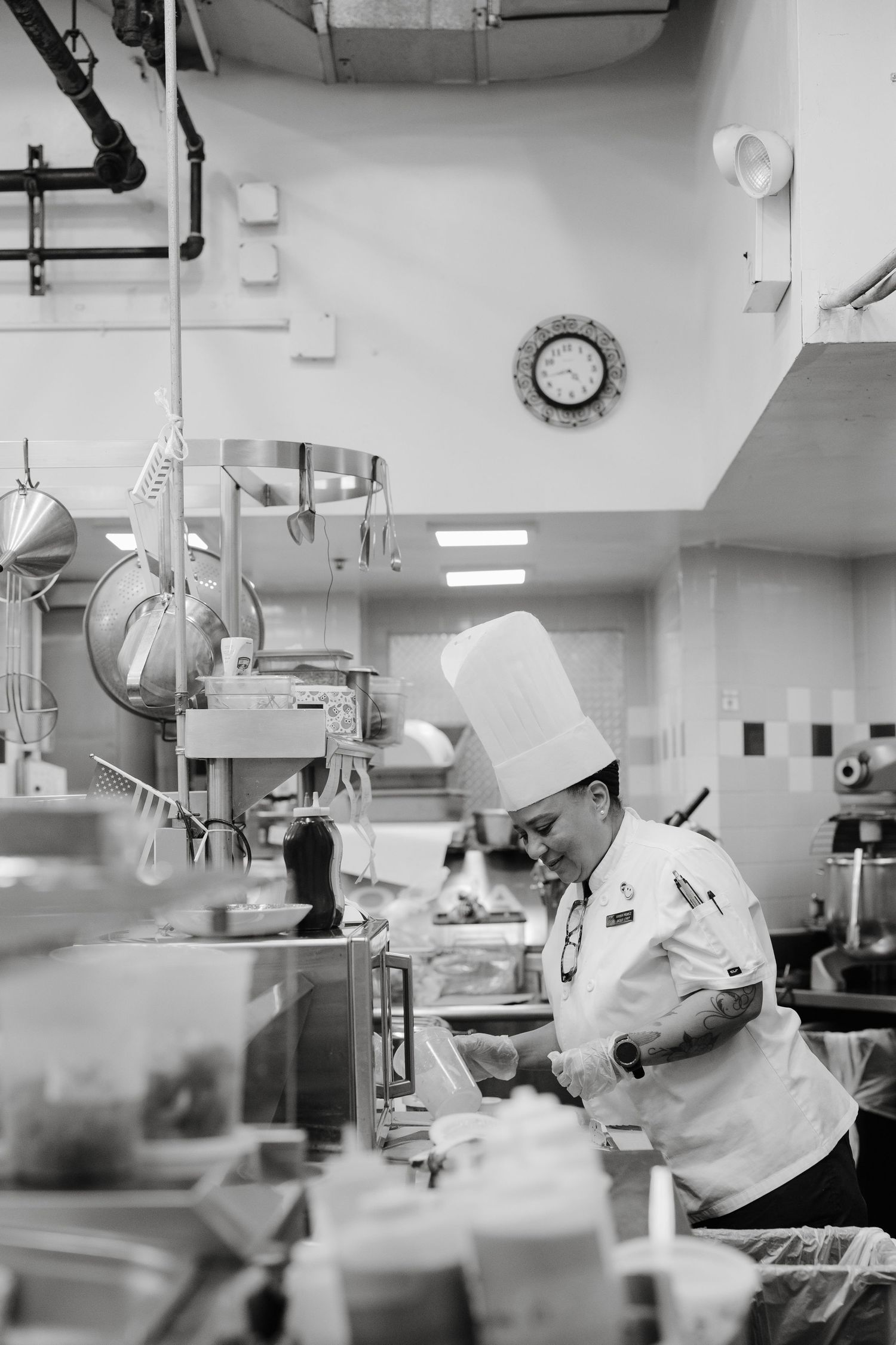 Medical professionals in surgical attire working in a busy operating room with medical equipment and bright lighting.