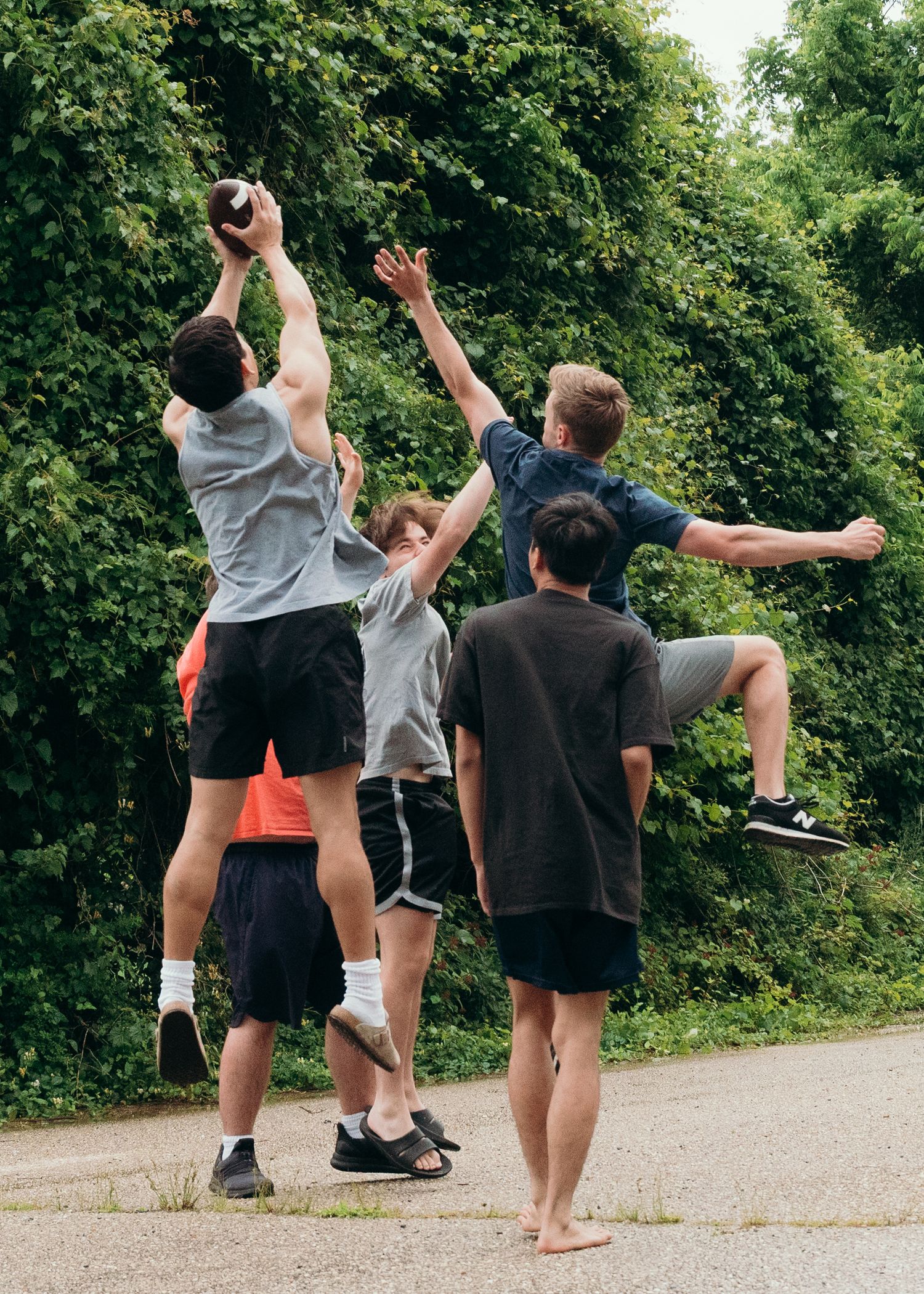 Group of people playing outdoor games and stretching in a park setting.