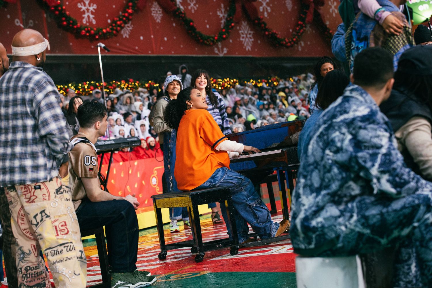 Spectators seated in a crowded stadium with colorful decorations and lighting.