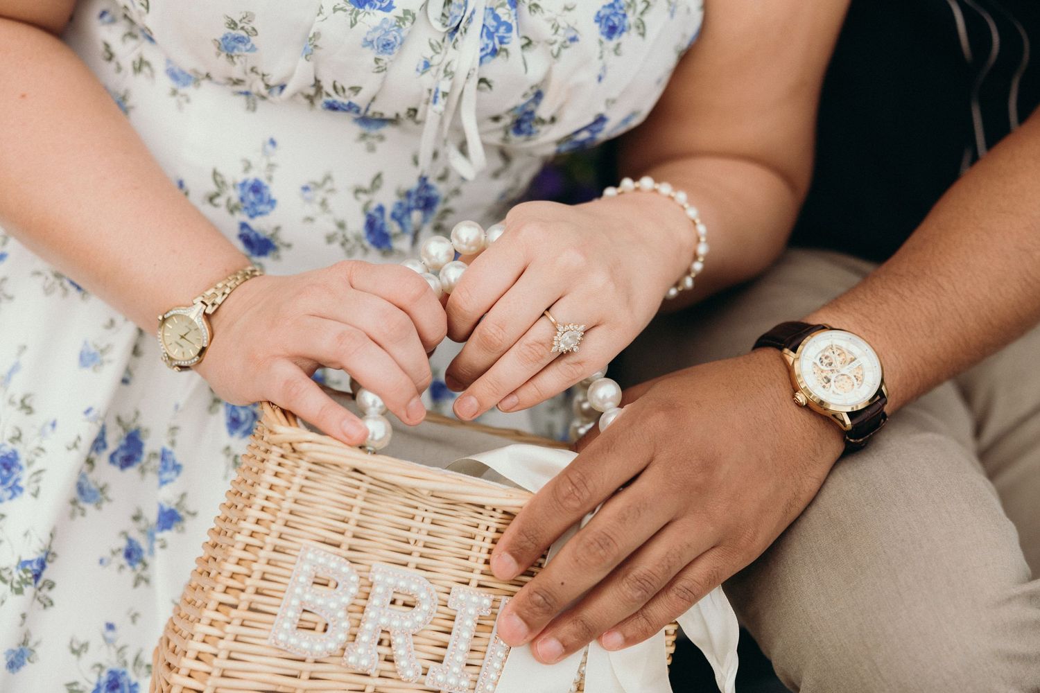 Close-up detail shots of hands holding and assembling a light woven wicker basket or container.
