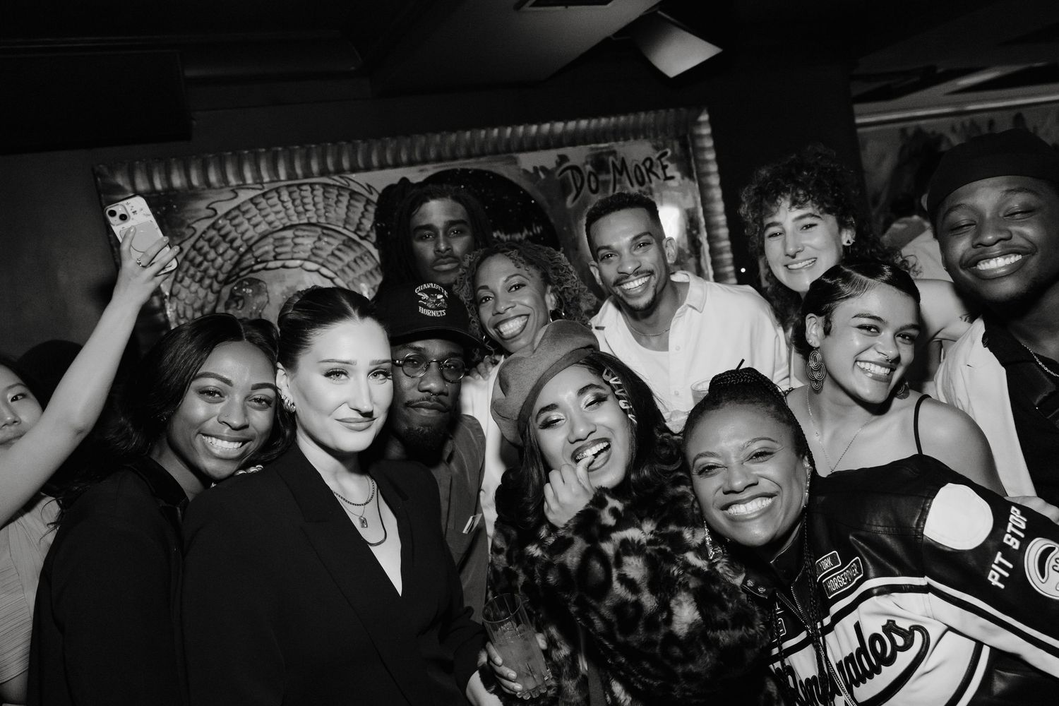 A collage of black and white photographs showing Hell's Kitchen cast enjoying a party or social gathering.