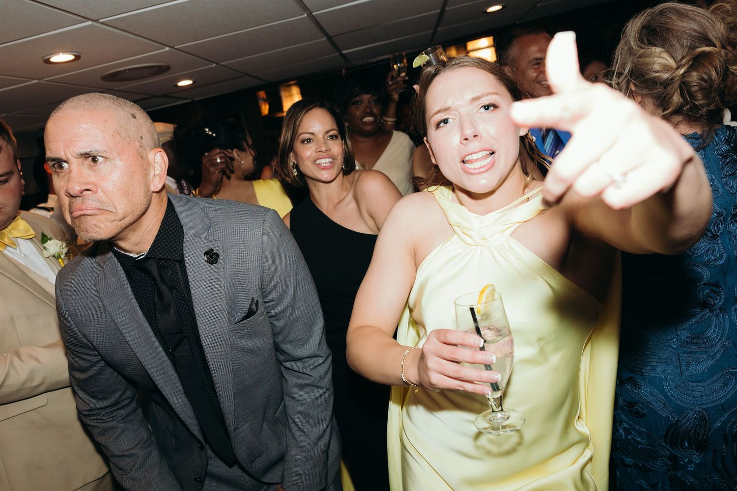 Guests dancing and celebrating at an indoor wedding reception party.