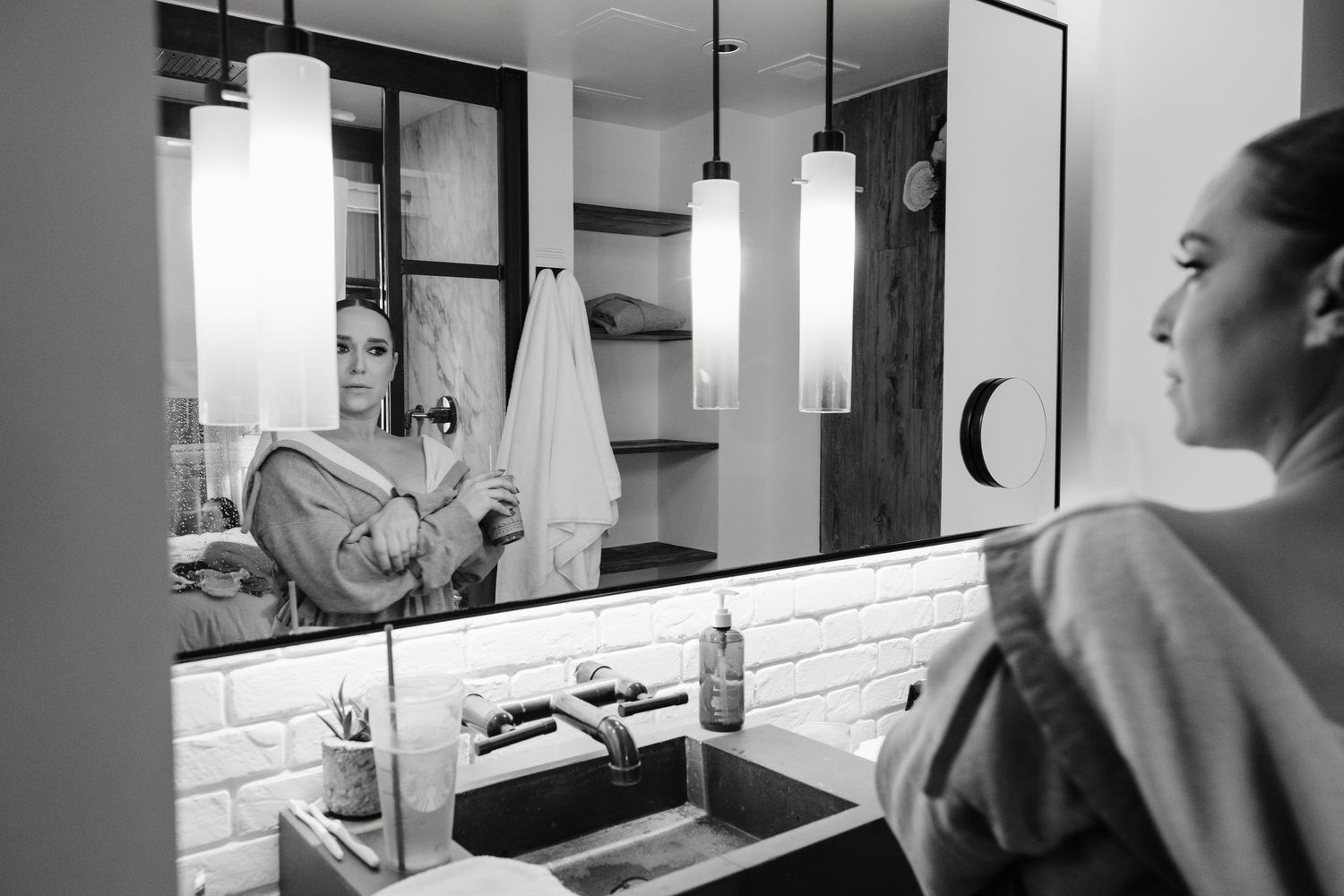 Black and white image showing a modern bathroom interior while Jessica Vosk Get Ready With Me