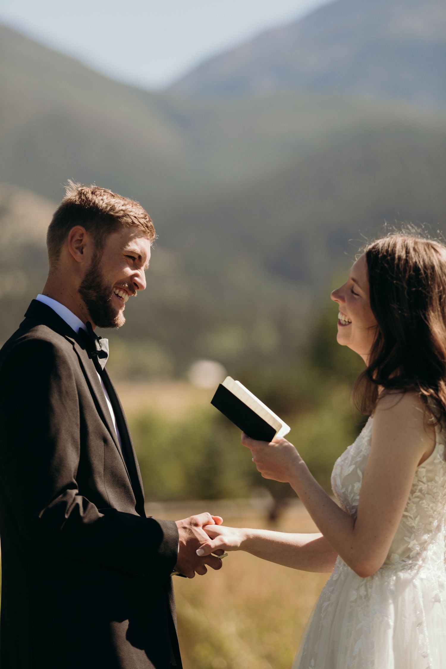 A couple exchanges vows during their outdoor mountain wedding ceremony.