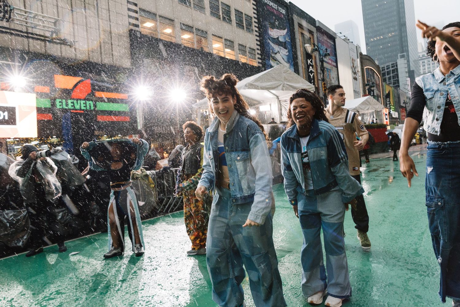 People dancing and celebrating on green pavement during festive street event.