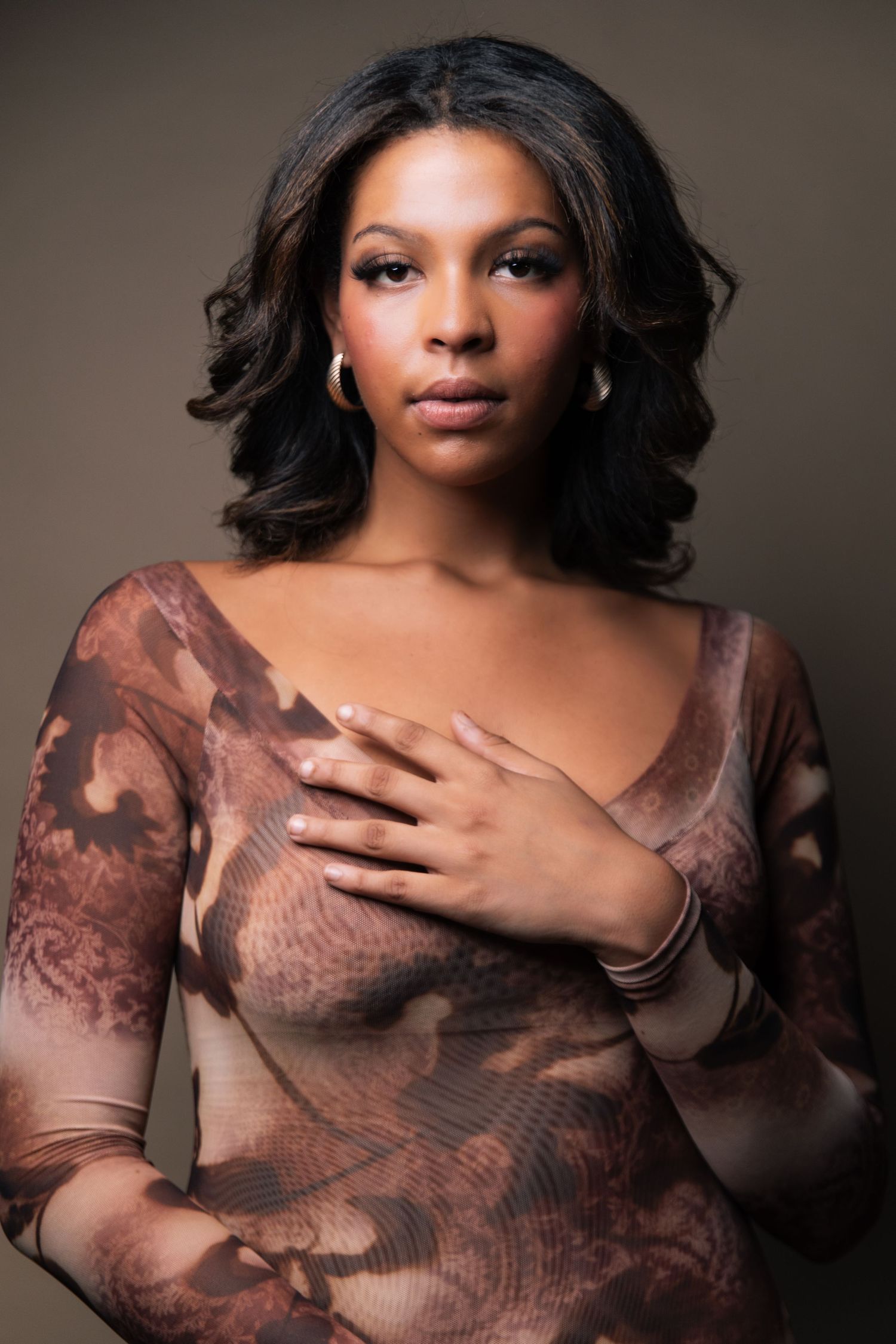 A series of glamour portraits featuring a person in brown lace against a dark background.
