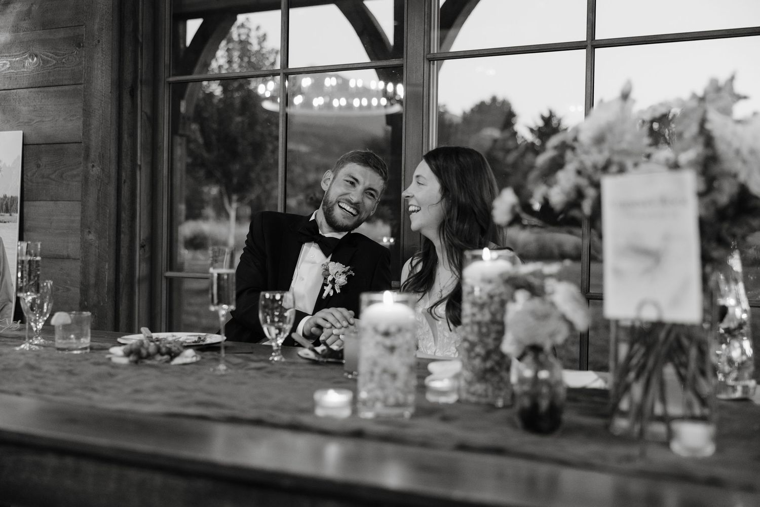 Black and white view through large windows at an elegant wedding venue.
