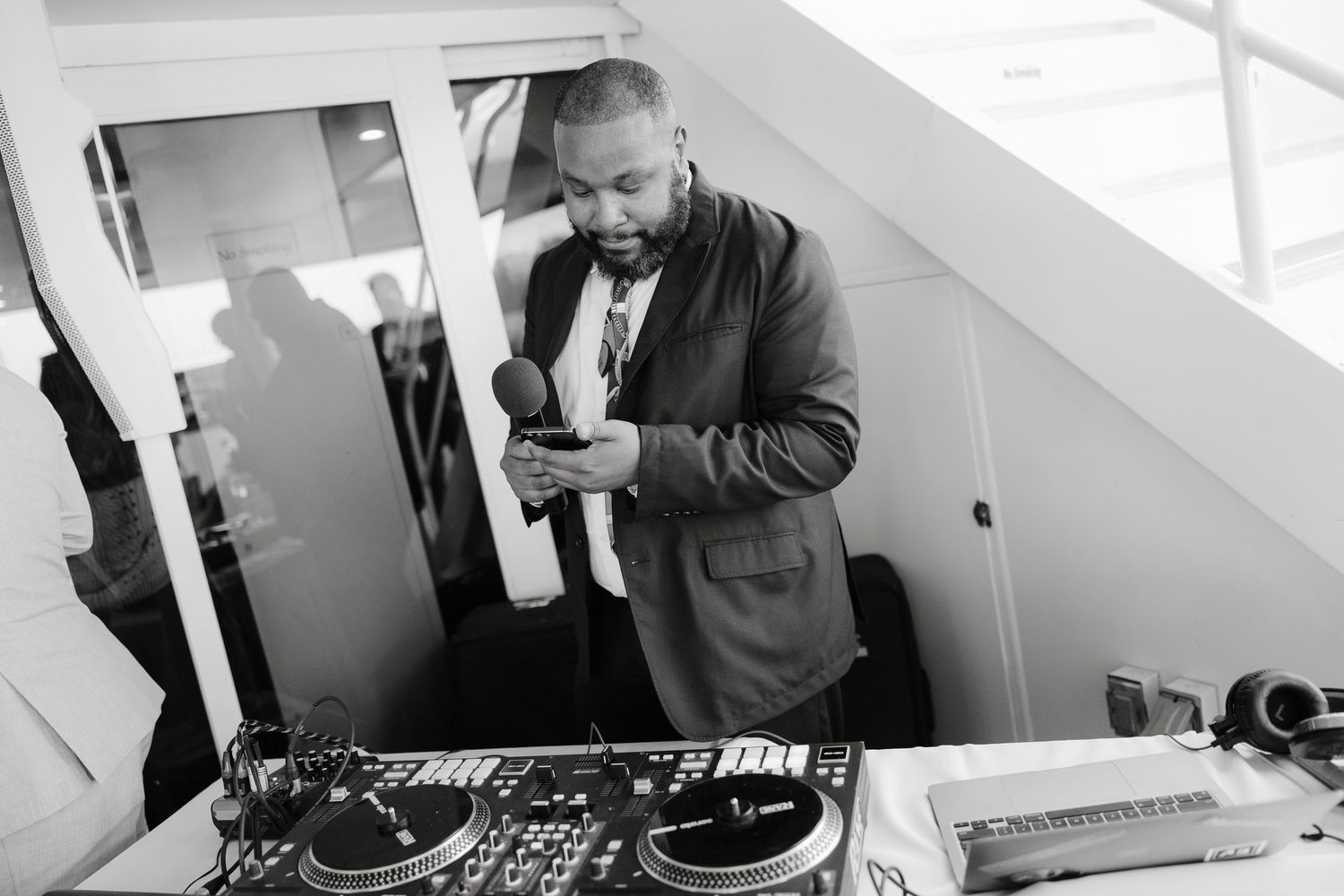 DJ equipment setup at a wedding reception with controllers and mixing boards.