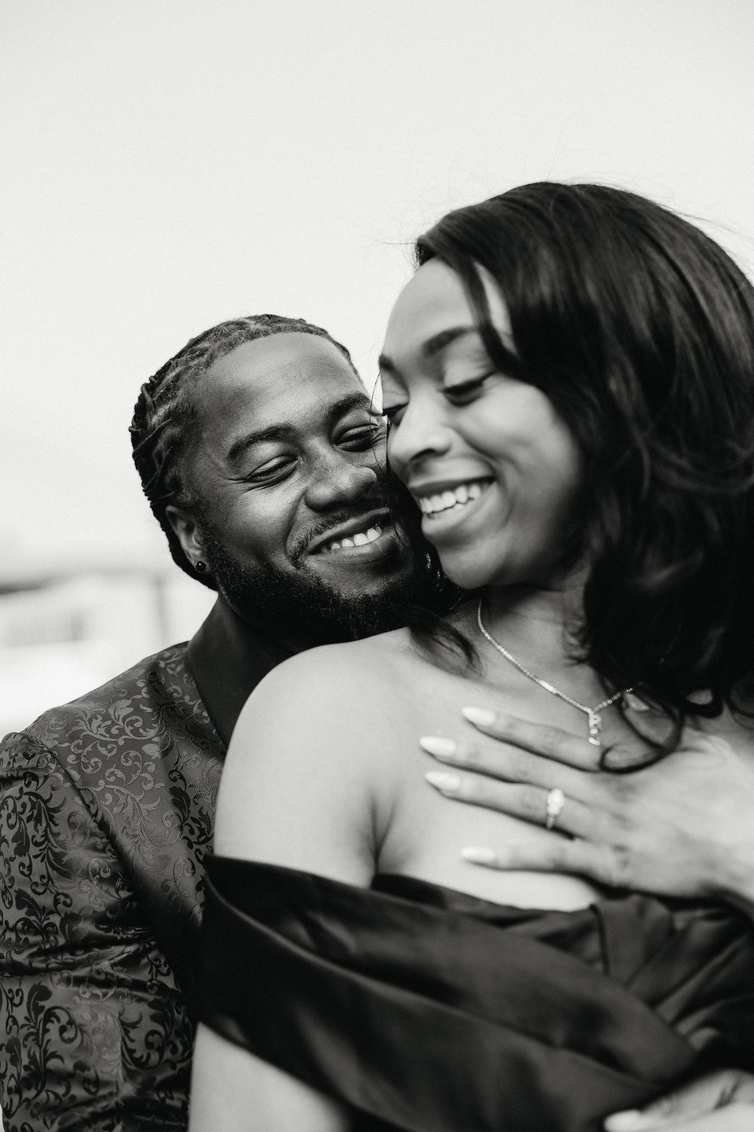 Intimate black and white portraits of a couple sharing tender moments together.