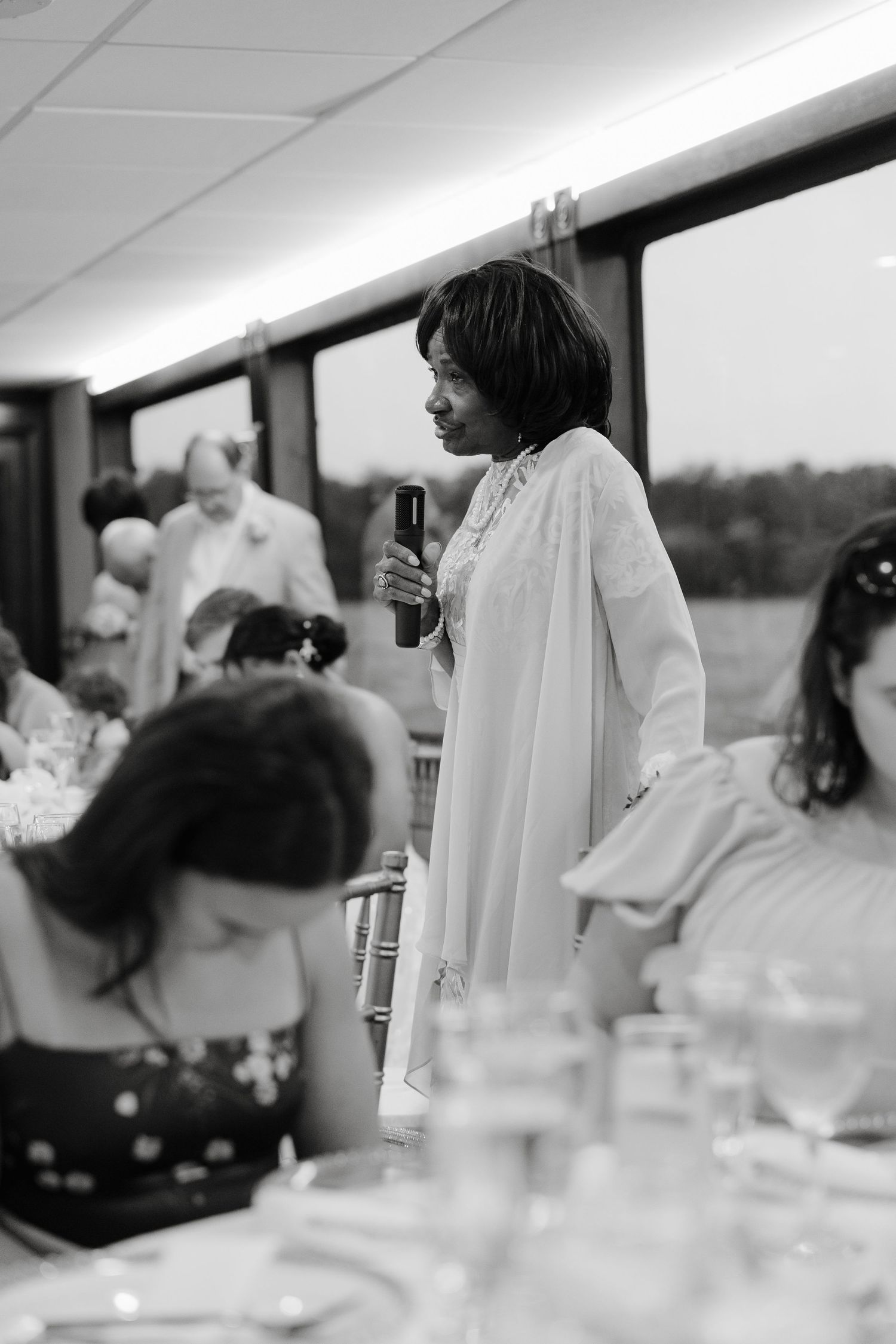 Elegant wedding reception table settings with glassware and white linens.