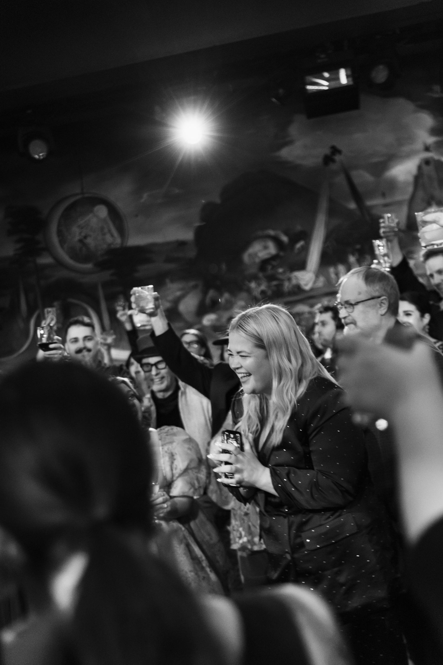 Jenny Anderson Black and white photo of an energetic crowd at a nighttime concert event.