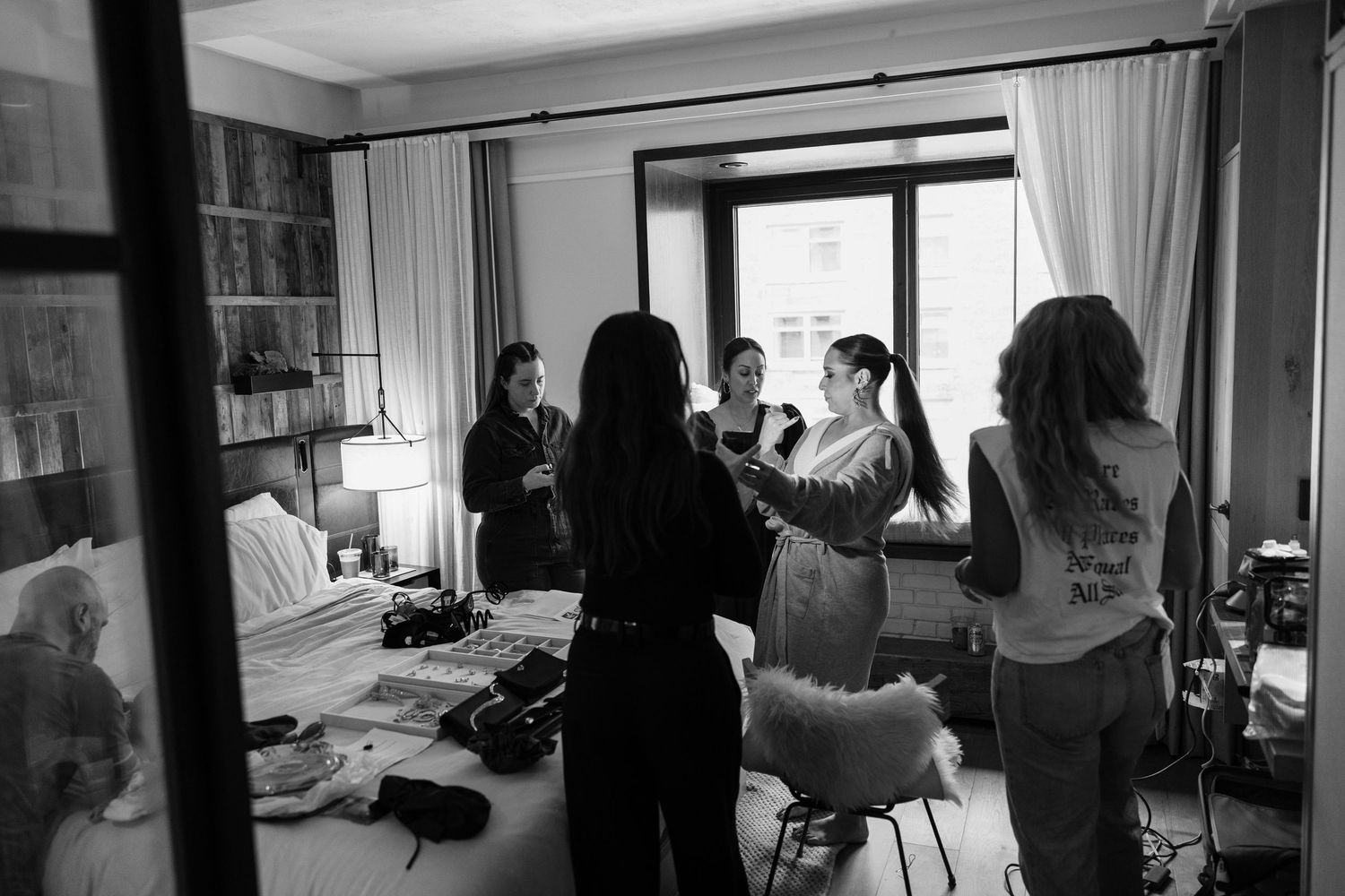 A series of black and white photos showing people working in an office space with large windows and modern furniture.