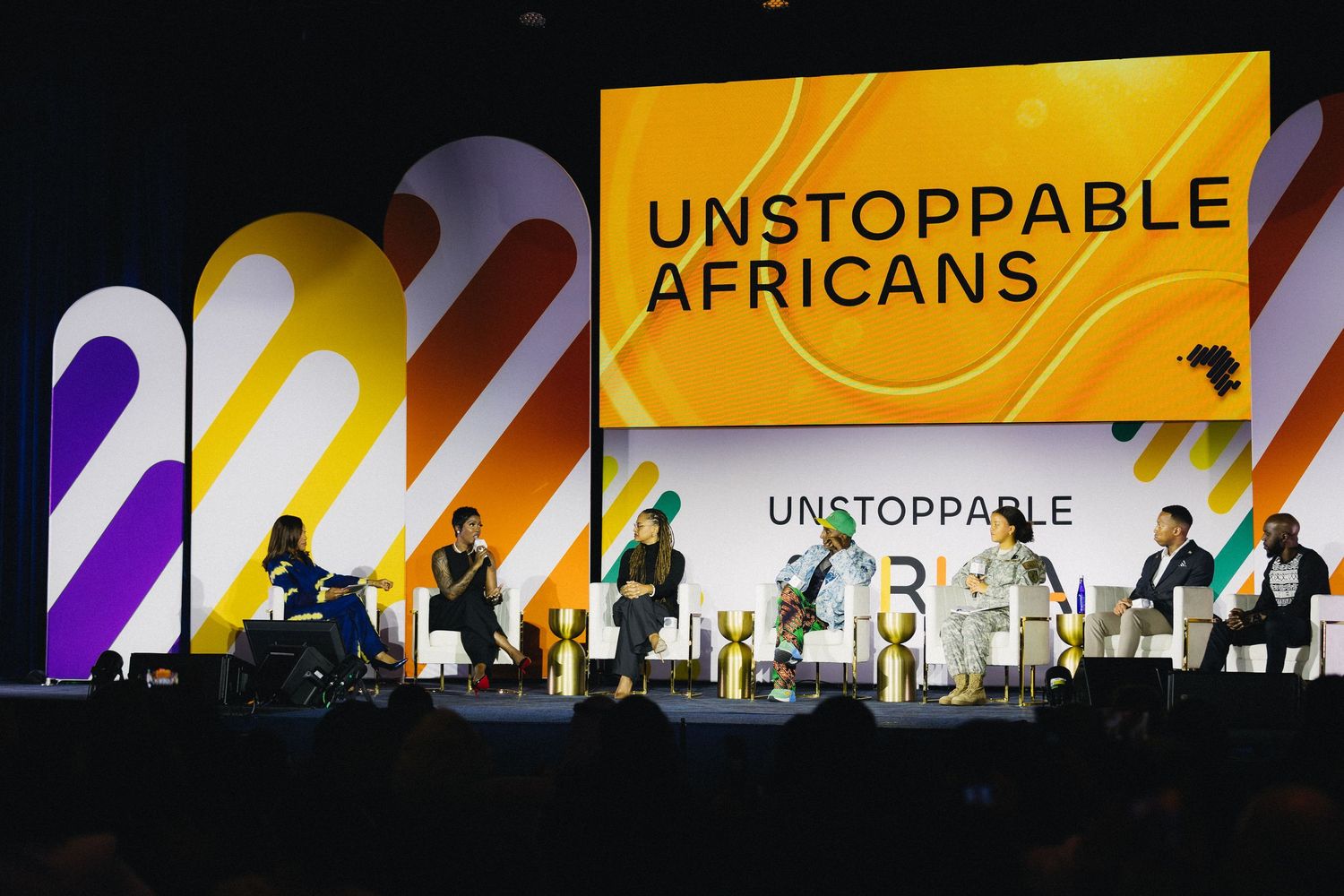 A series of event stage banners showing text 'UNSTOPPABLE' and 'AFRICANS' with dramatic lighting and silhouetted figures.