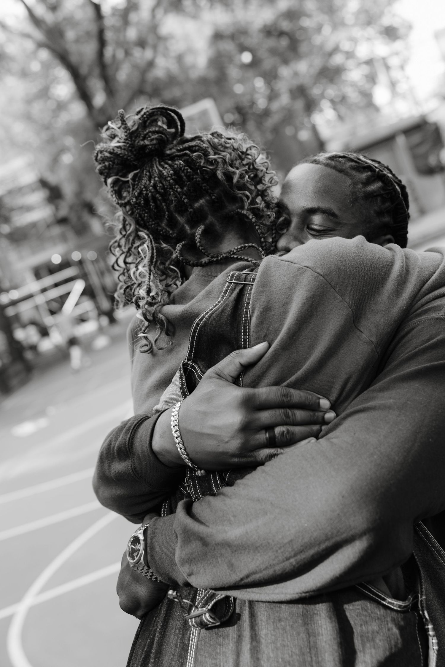 Black and white series showing an intimate embrace outdoors.