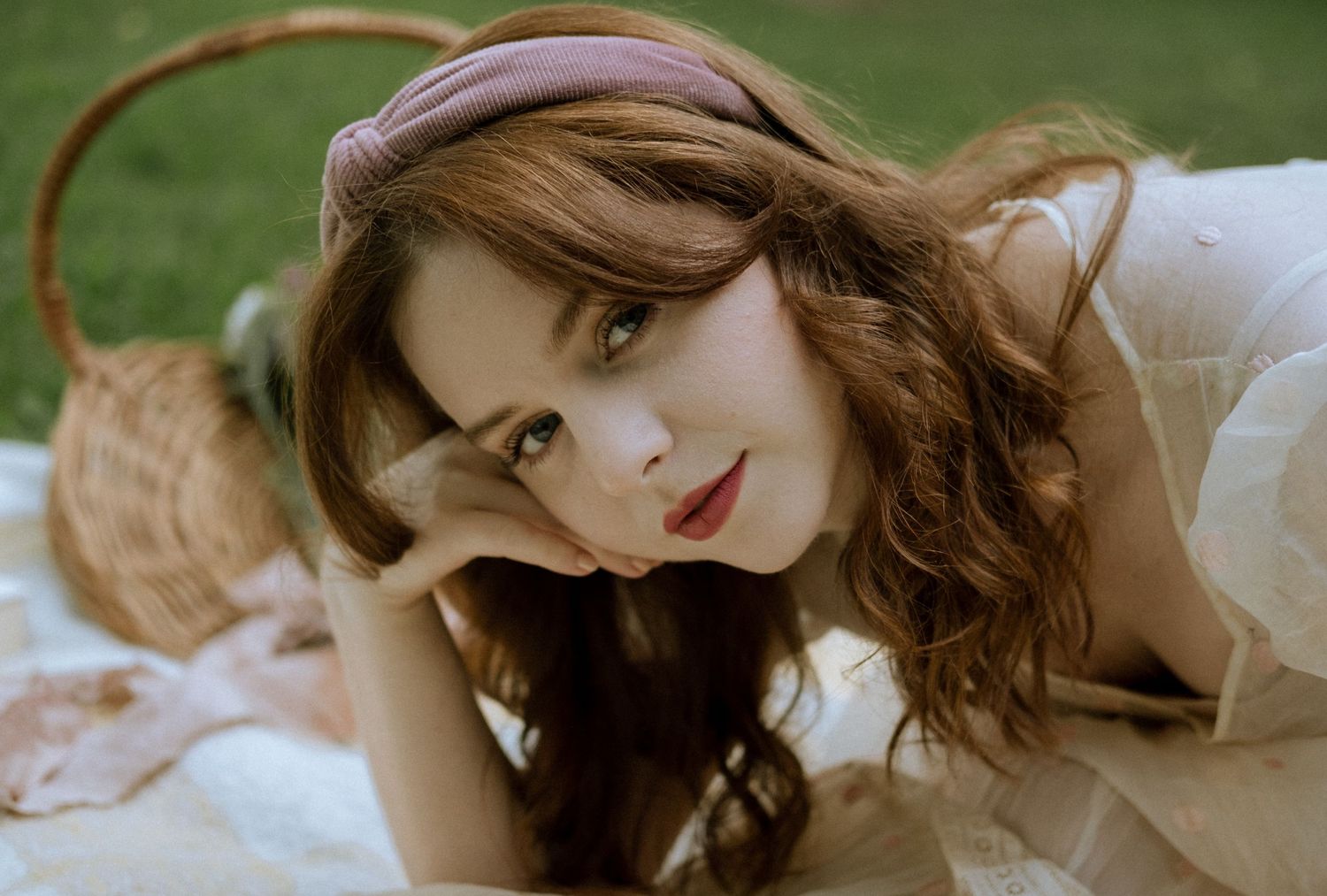Photo of a girl in a garden wearing a vintage dress