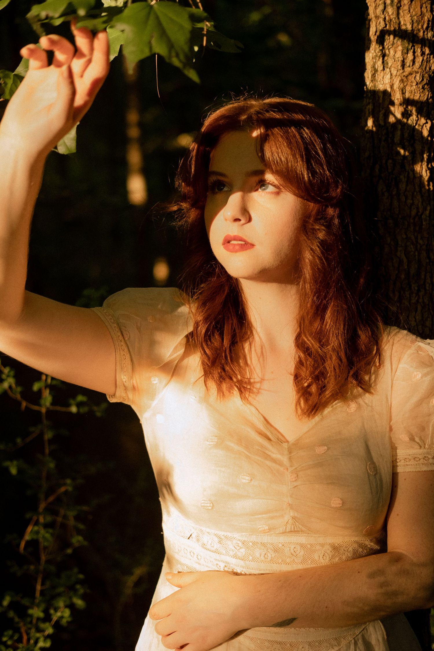 Photo of two girls in a forest wearing a vintage dress