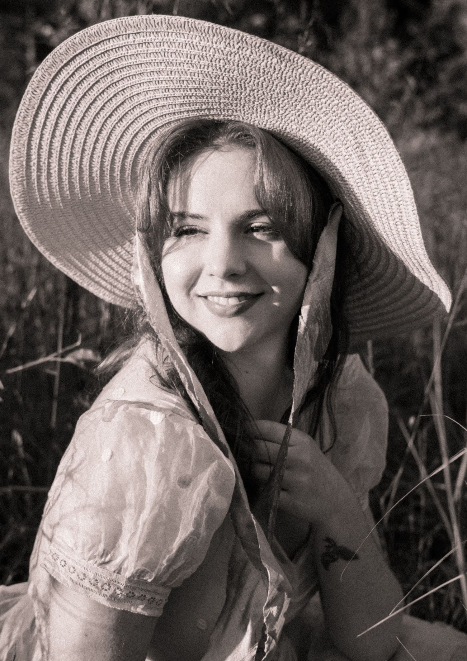 Photo of two girls in a field wearing a vintage dress at golden hour