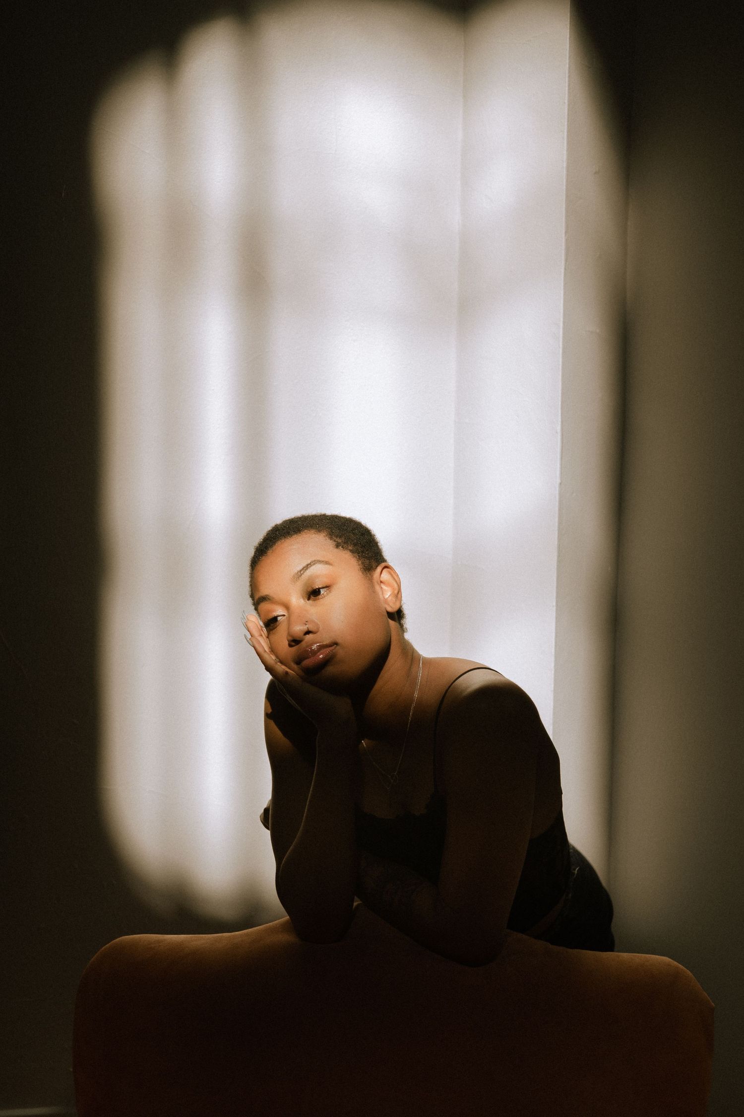 Girl half in shadow with window light
