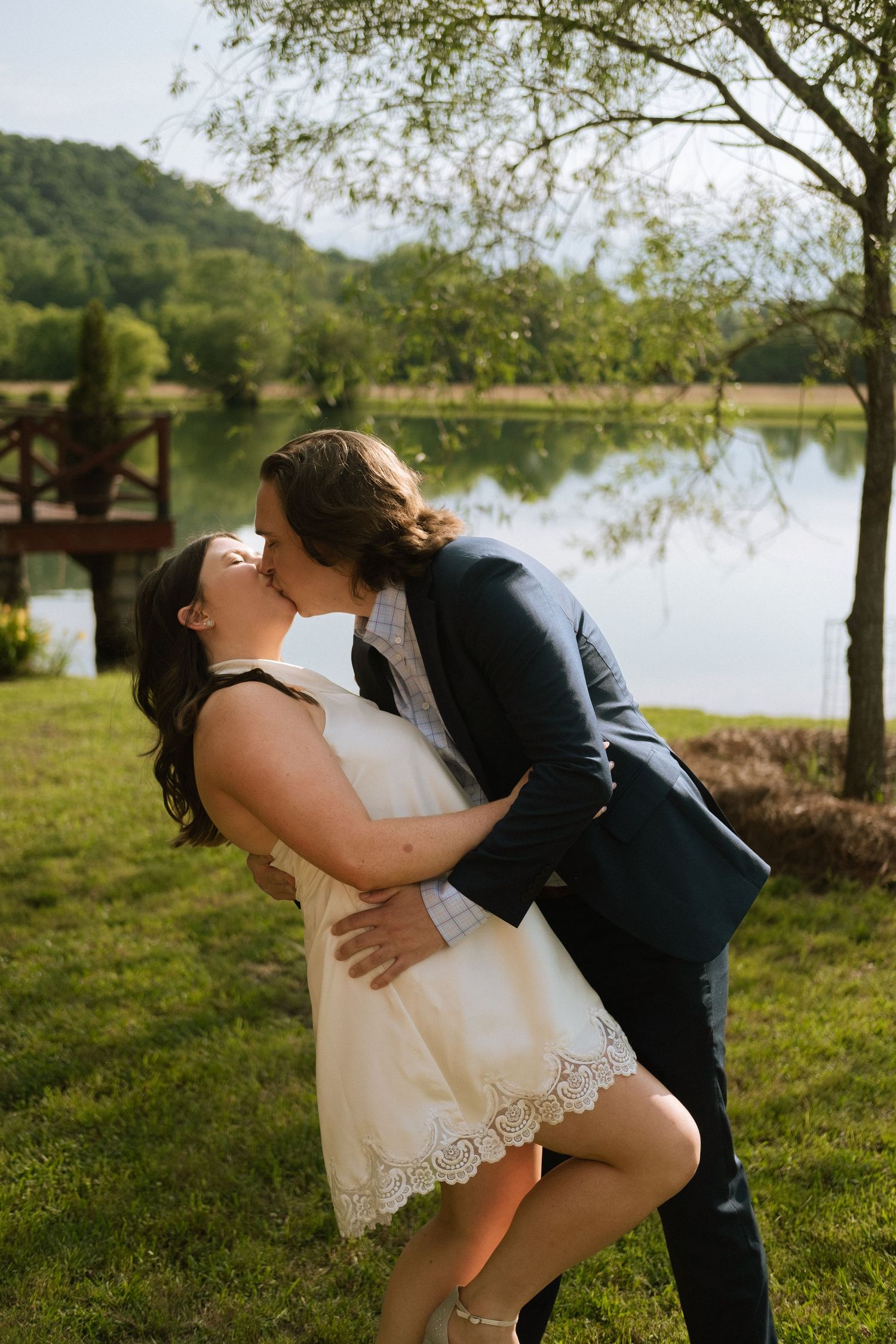 Couple kissing in front of a lake