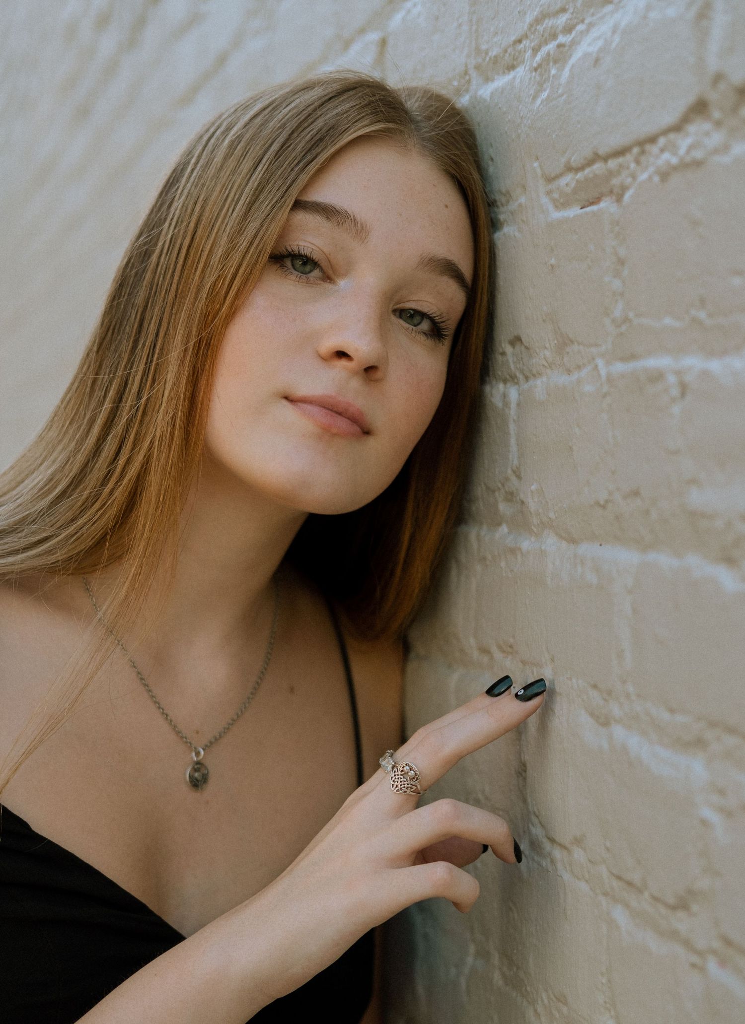 Photo of a high school senior in Atlanta against a white brick wall