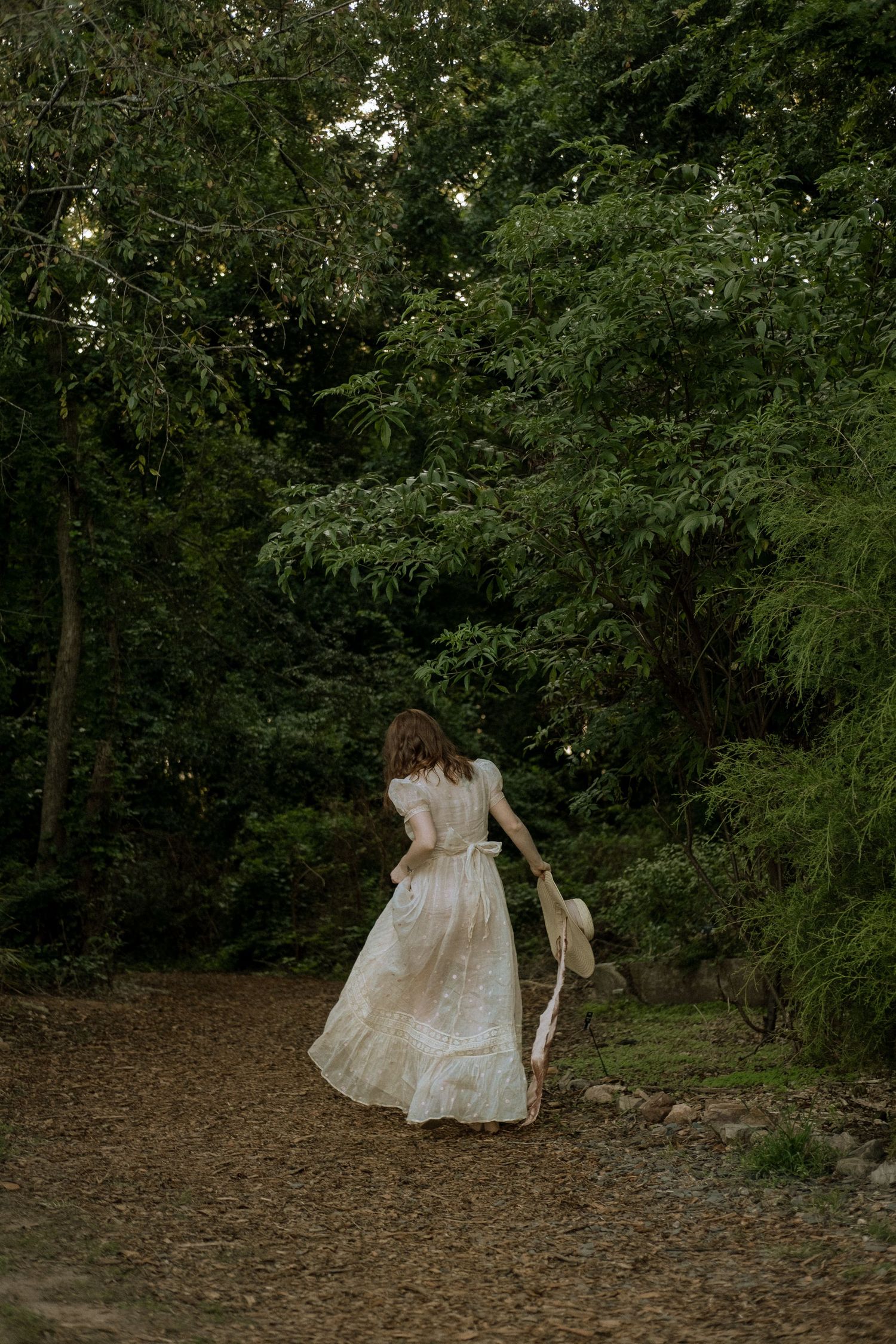 Photo of two girls in a forest wearing a vintage dress