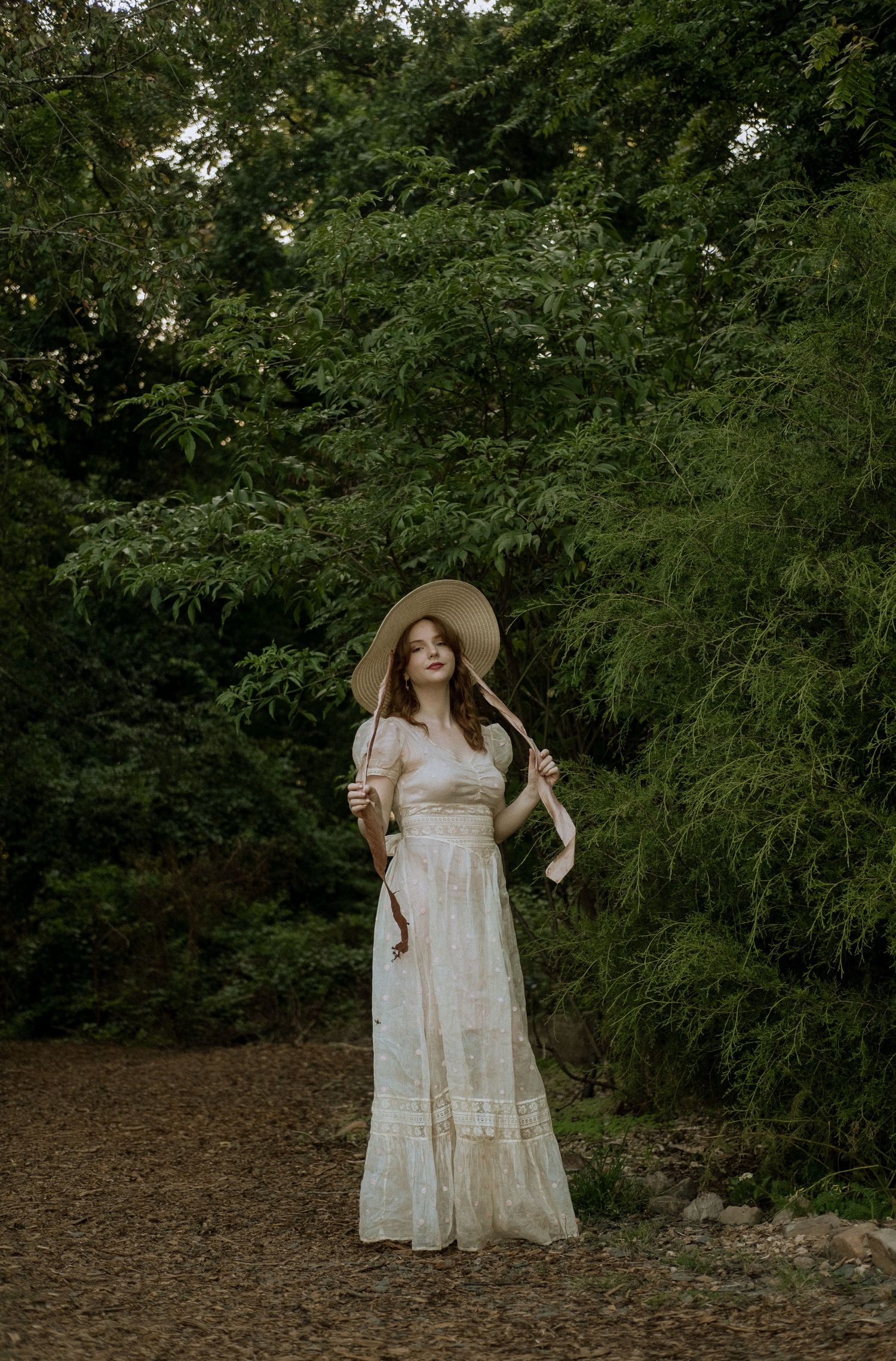Photo of two girls in a forest wearing a vintage dress