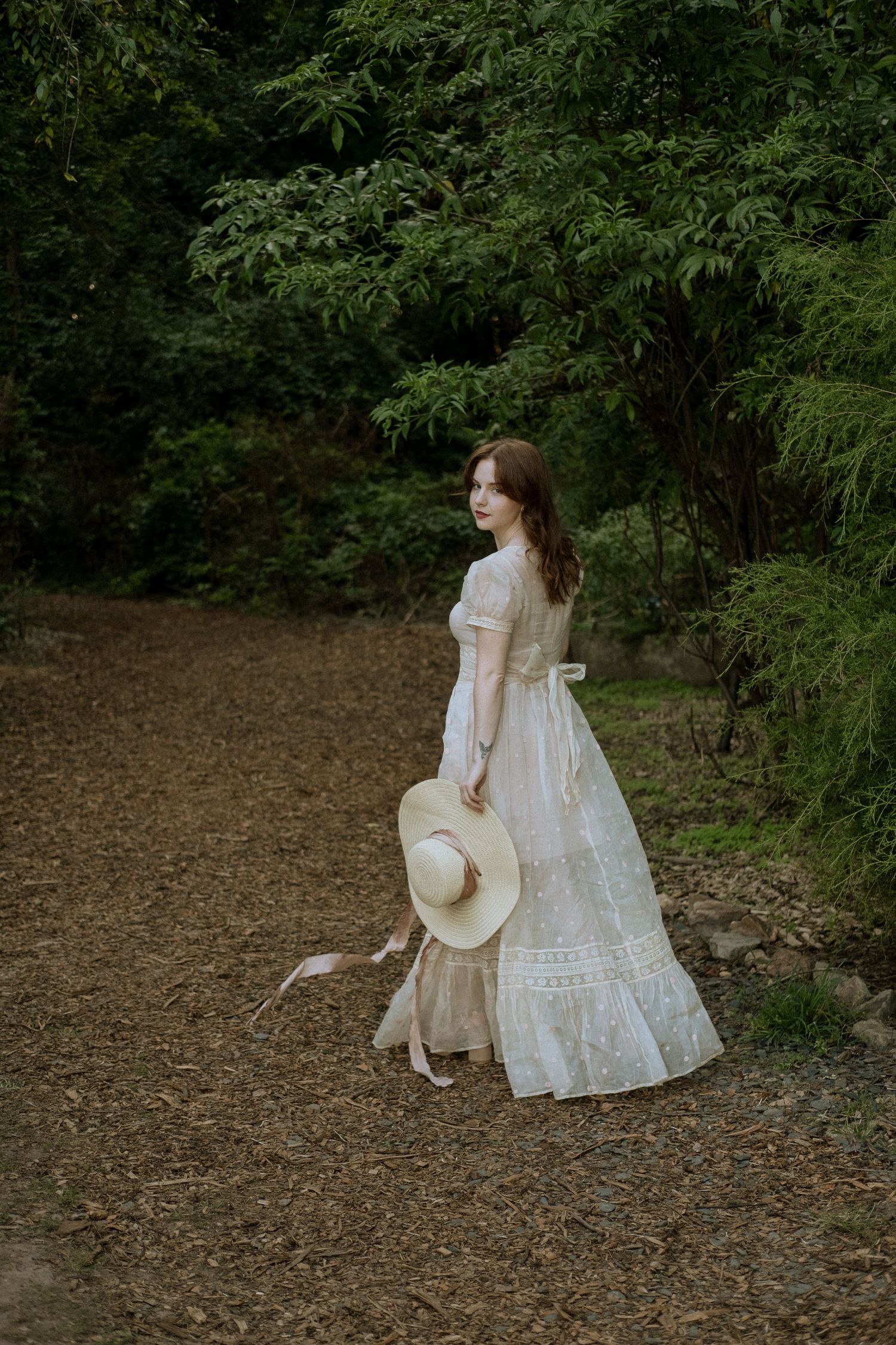 Photo of two girls in a forest wearing a vintage dress