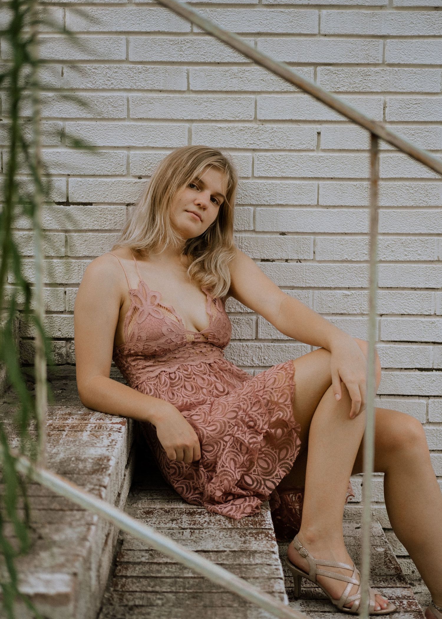 Photo of a girl sitting on the stairs of an abandoned building