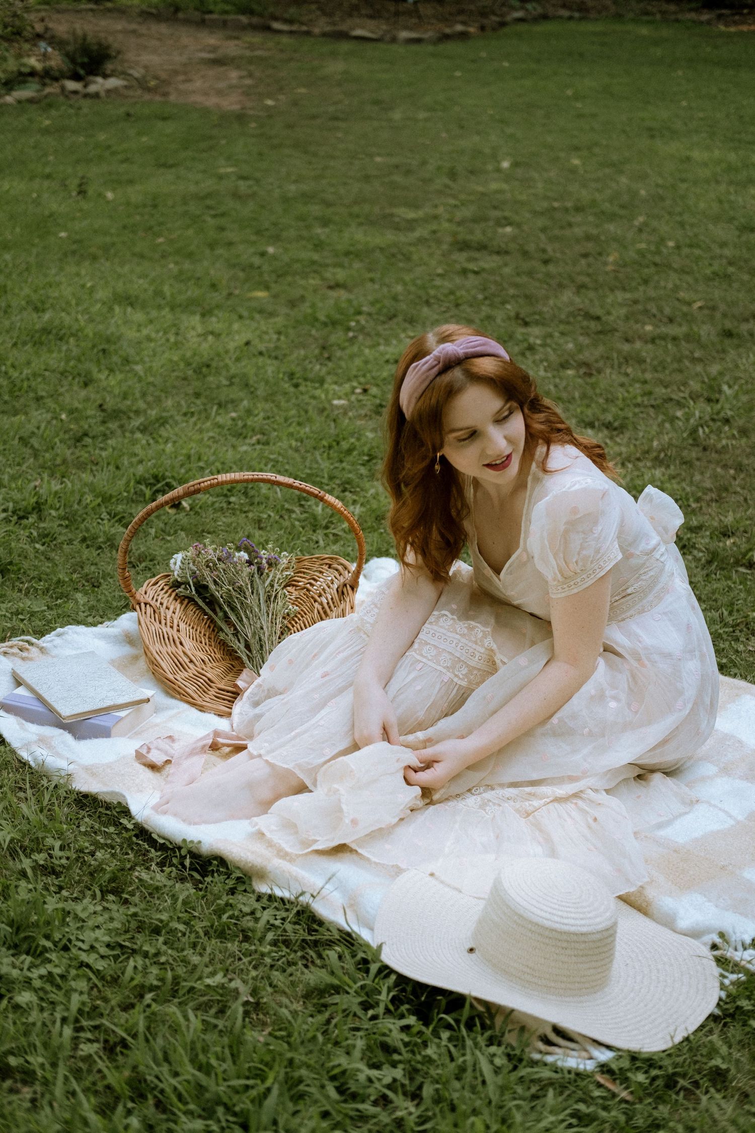 Photo of a girl in a garden wearing a vintage dress