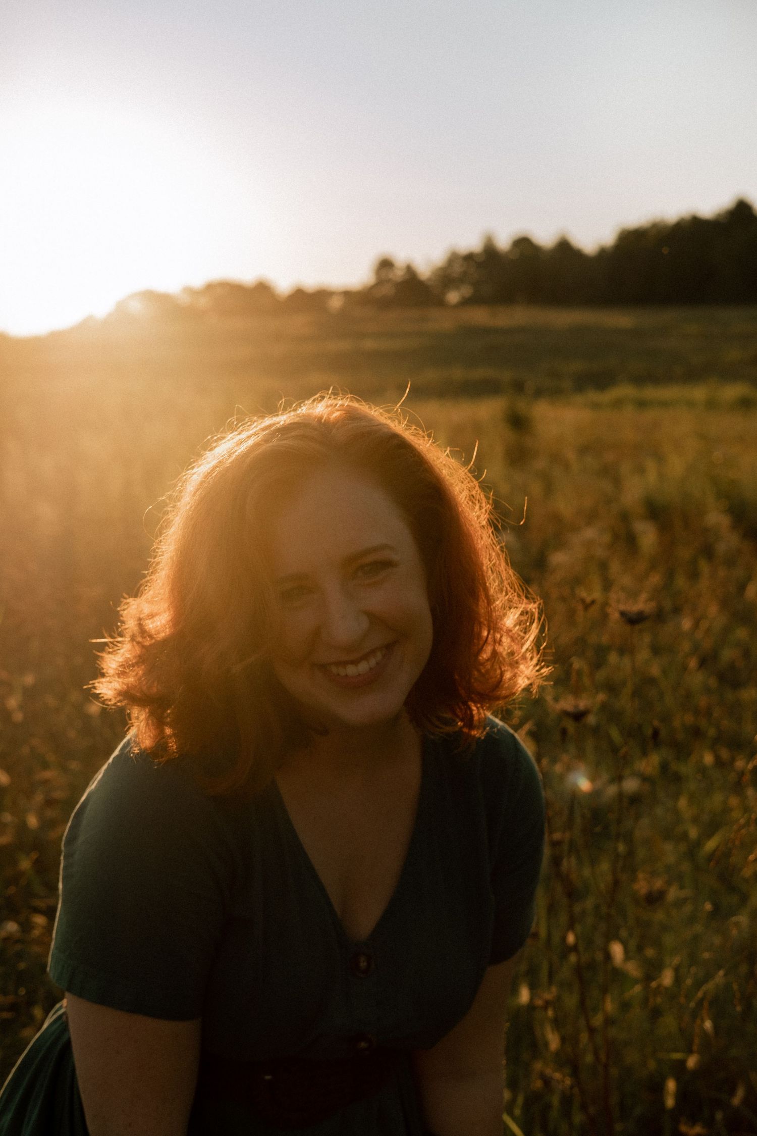 Photo of two girls in a field wearing a vintage dress at golden hour
