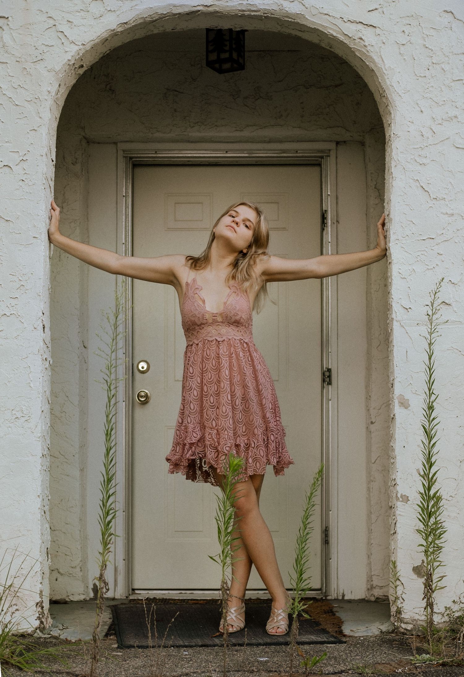Photo of a girl against in the doorway of an abandoned building