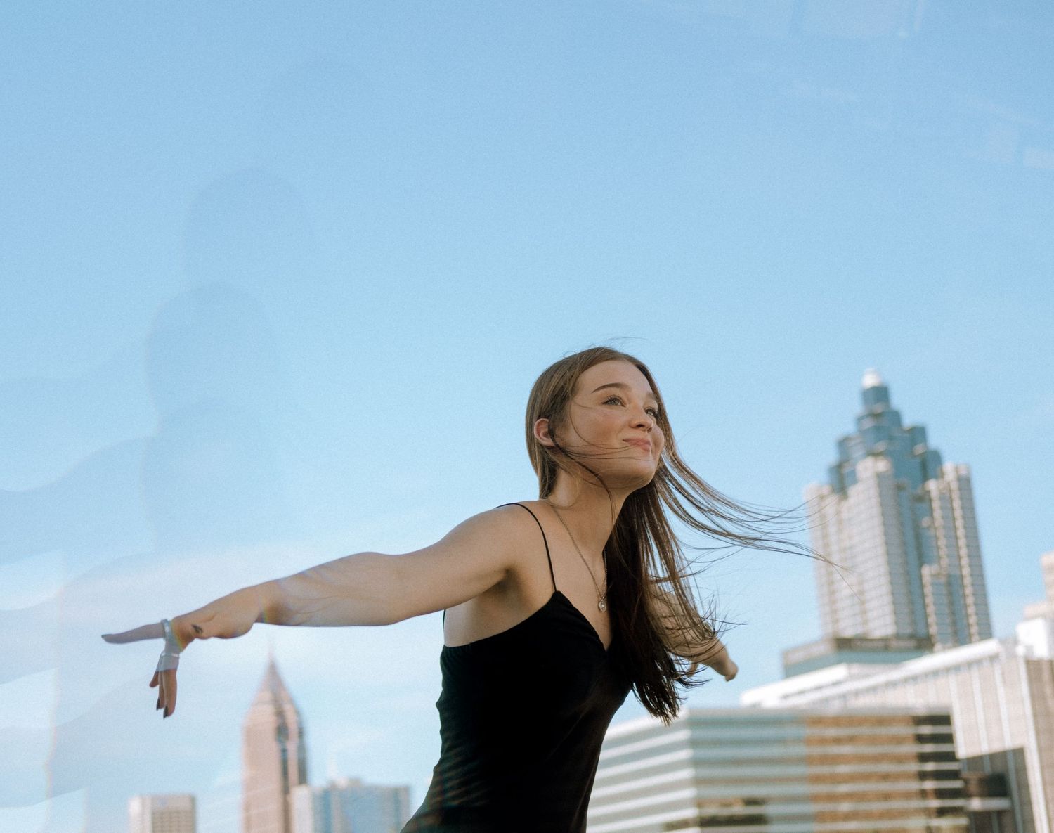 Photo of a high school senior with the Atlanta skyline