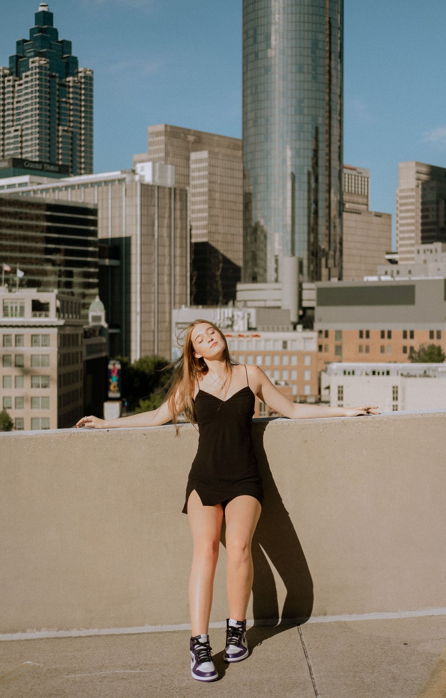 Photo of a high school senior with the Atlanta skyline