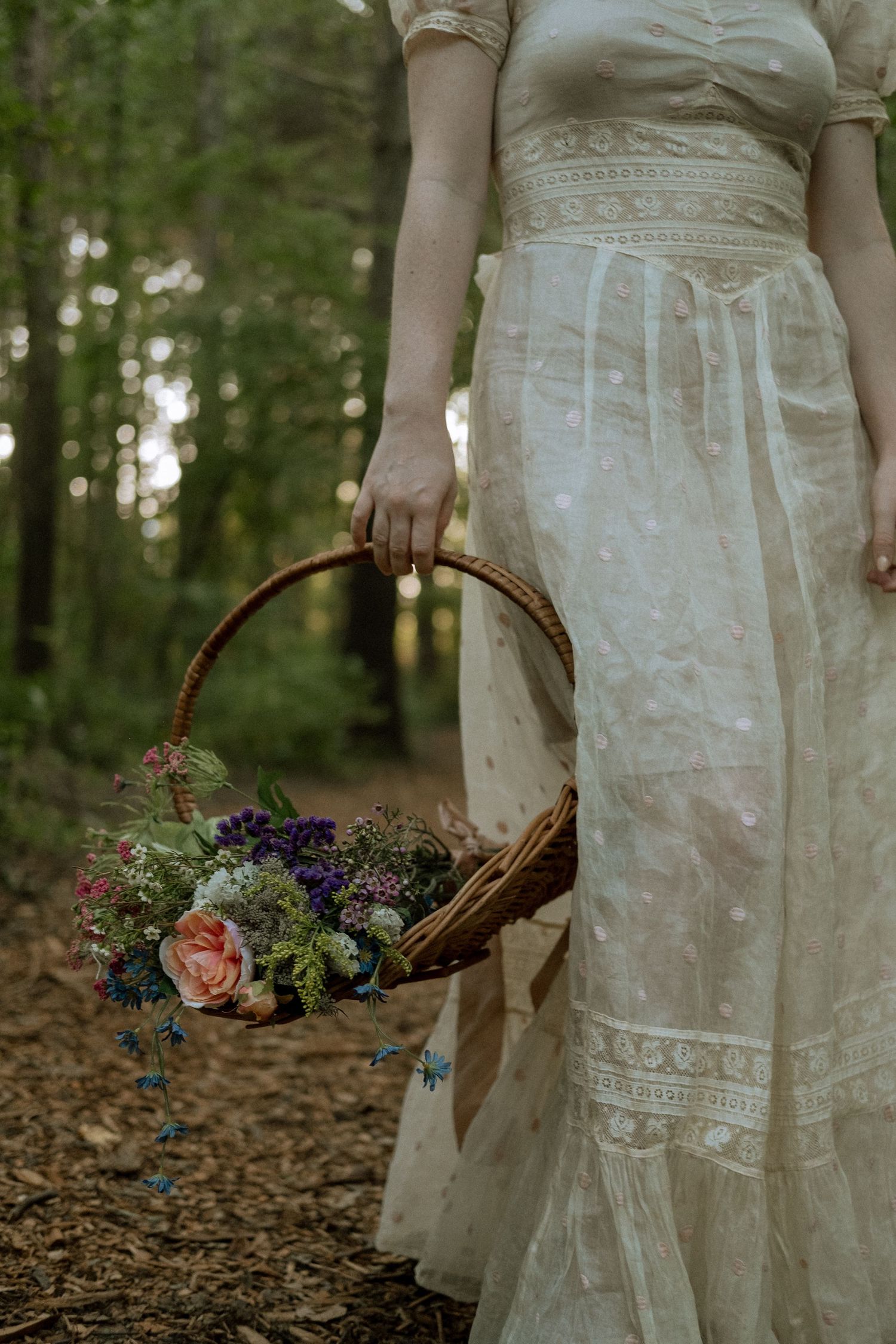 Photo of two girls in a forest wearing a vintage dress