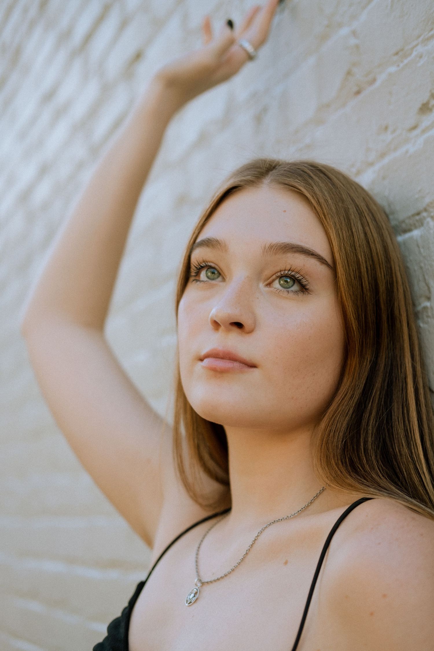 Photo of a high school senior in Atlanta against a white brick wall