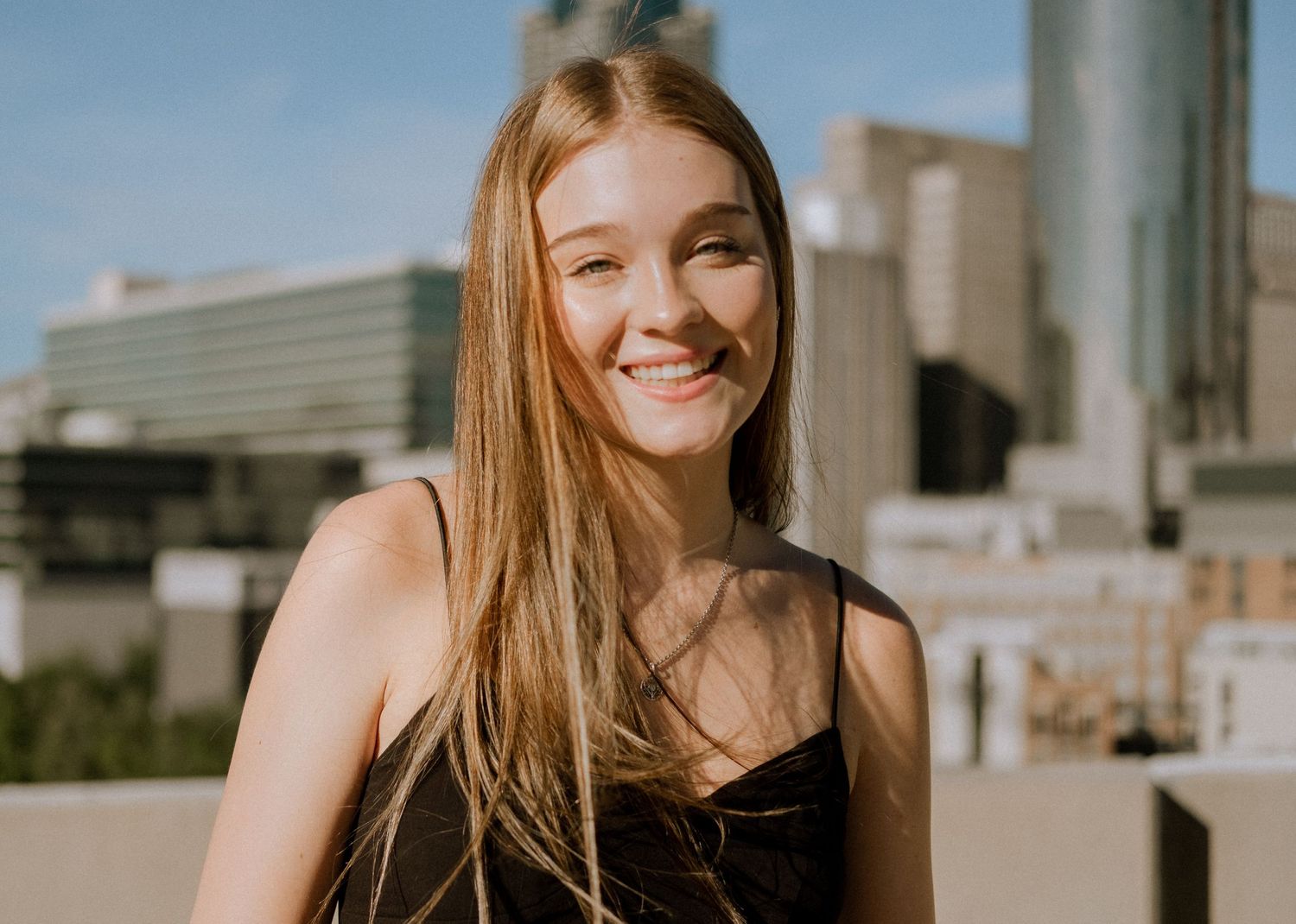 Photo of a high school senior with the Atlanta skyline