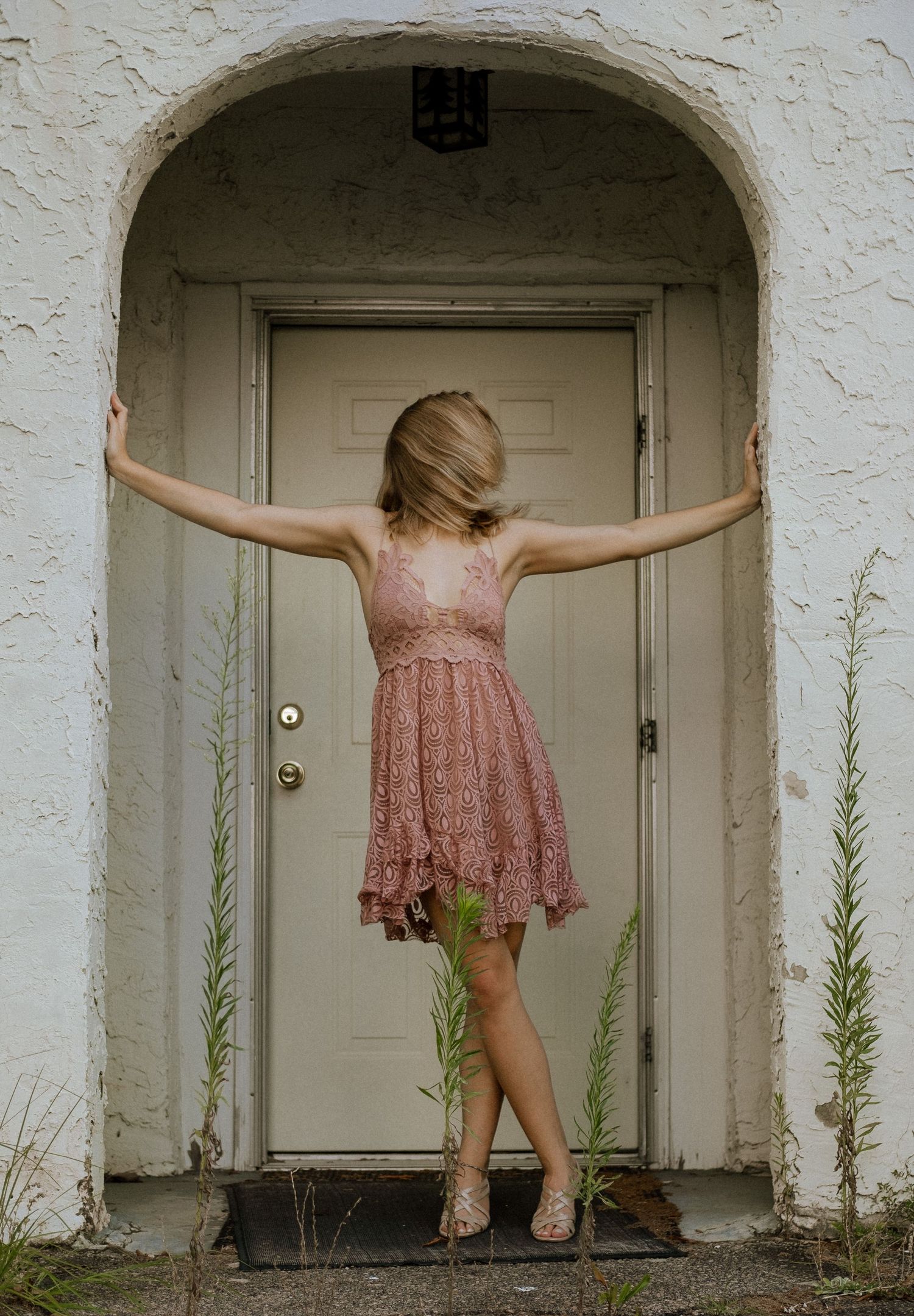 Photo of a girl against in the doorway of an abandoned building